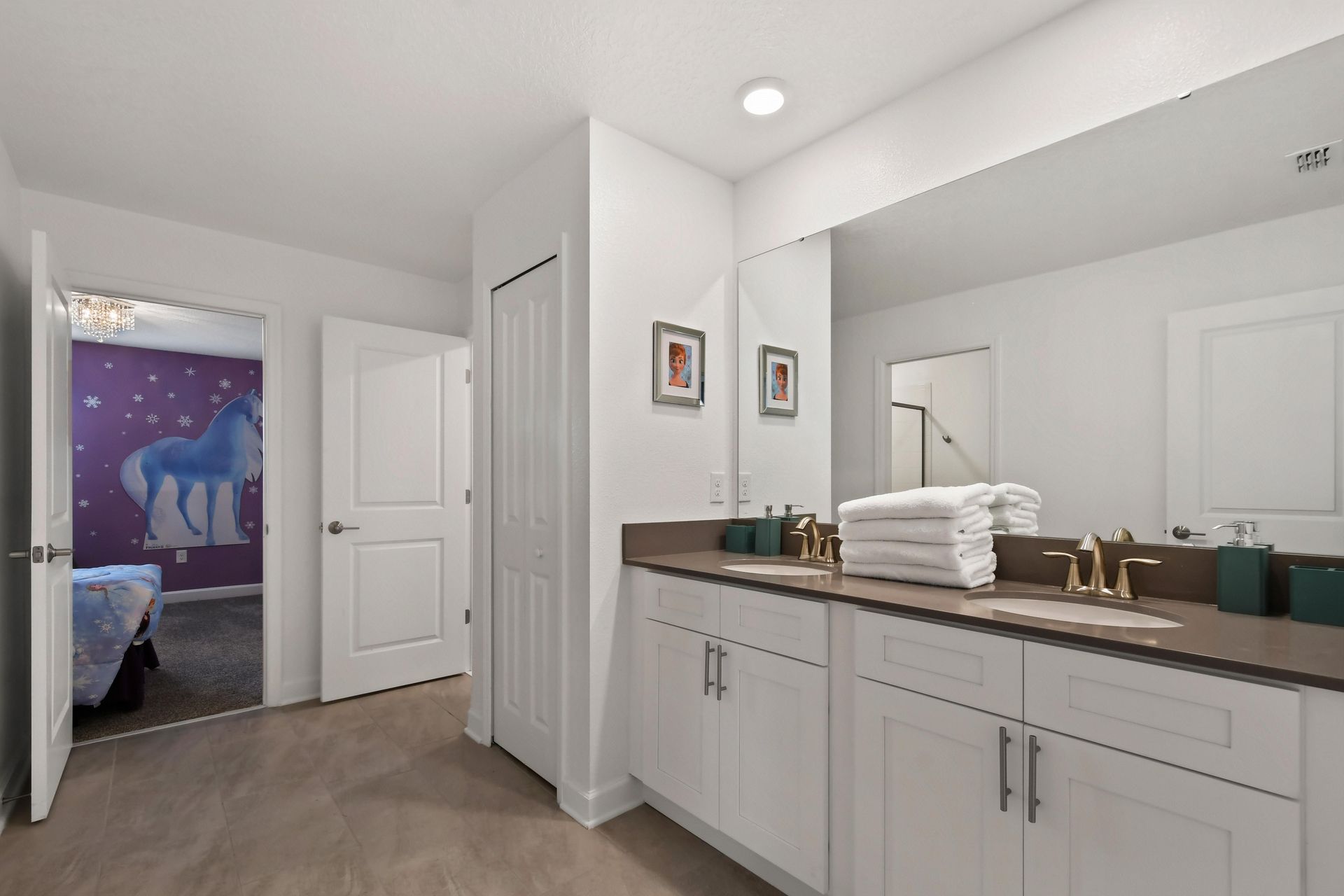 Bright and modern bathroom with a dual-sink vanity, sleek finishes, and elegant decor.