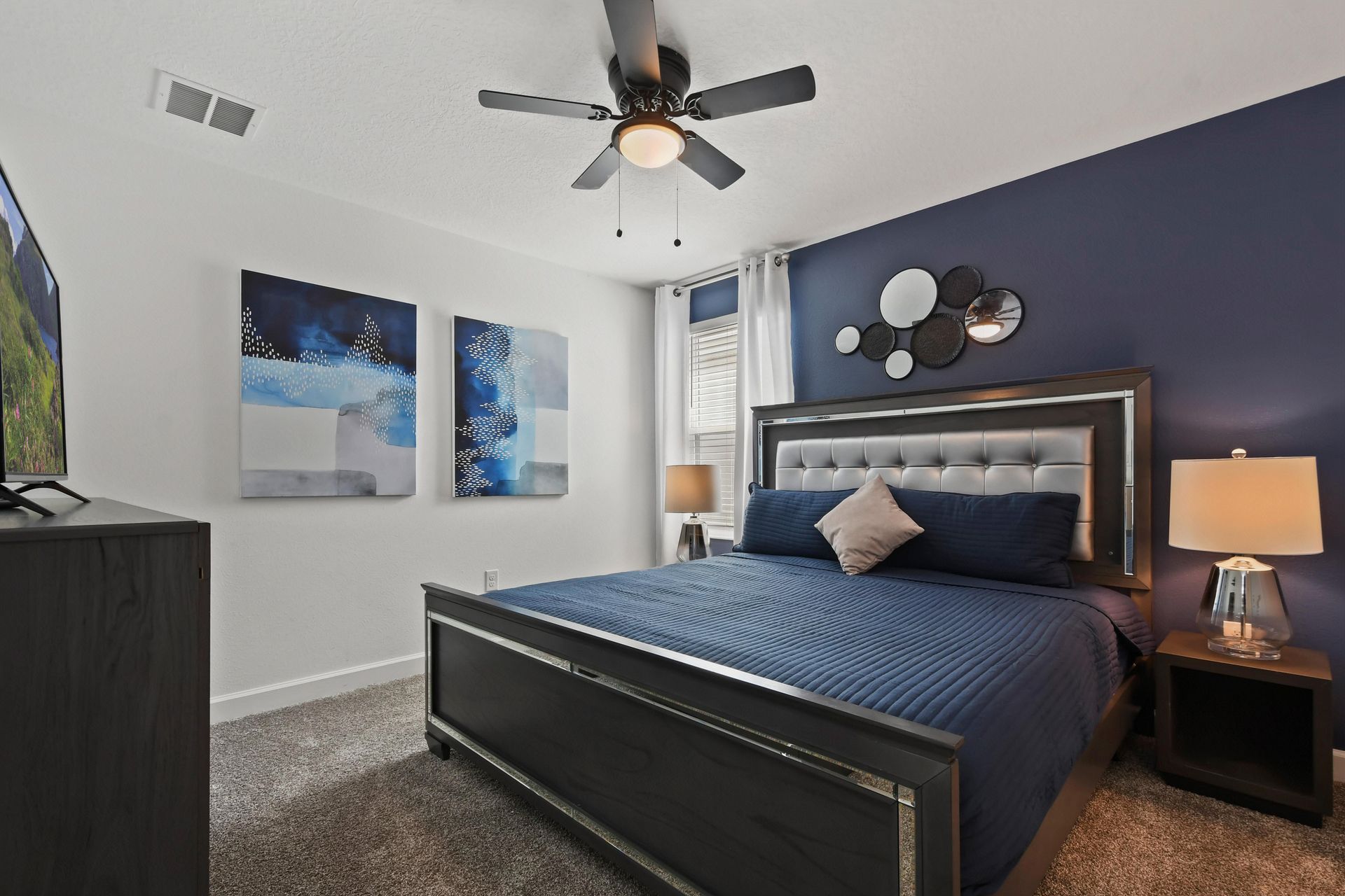Sophisticated bedroom with a plush king bed, modern decor, and calming blue tones.