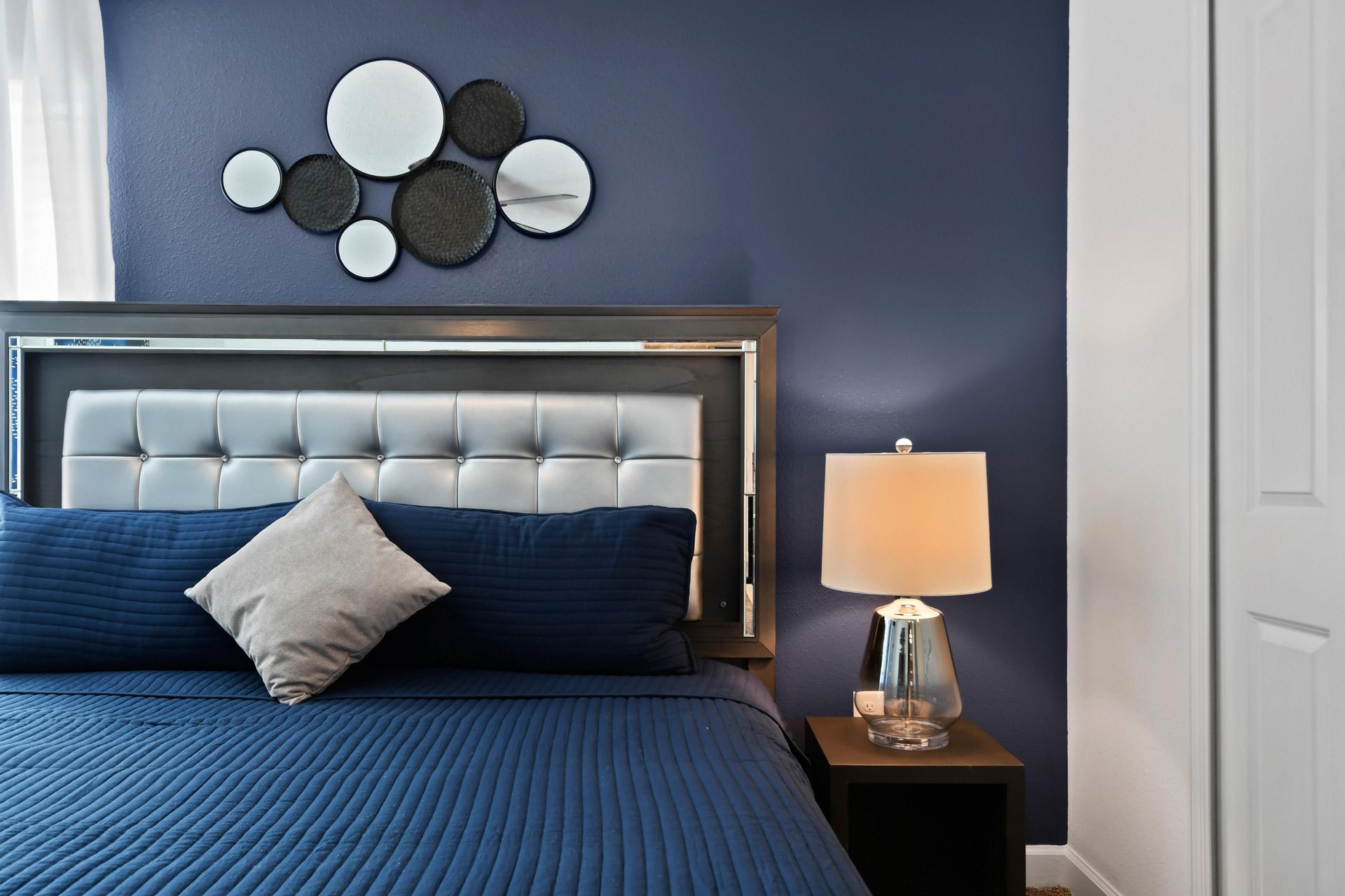 Sophisticated bedroom with a plush king bed, modern decor, and calming blue tones.