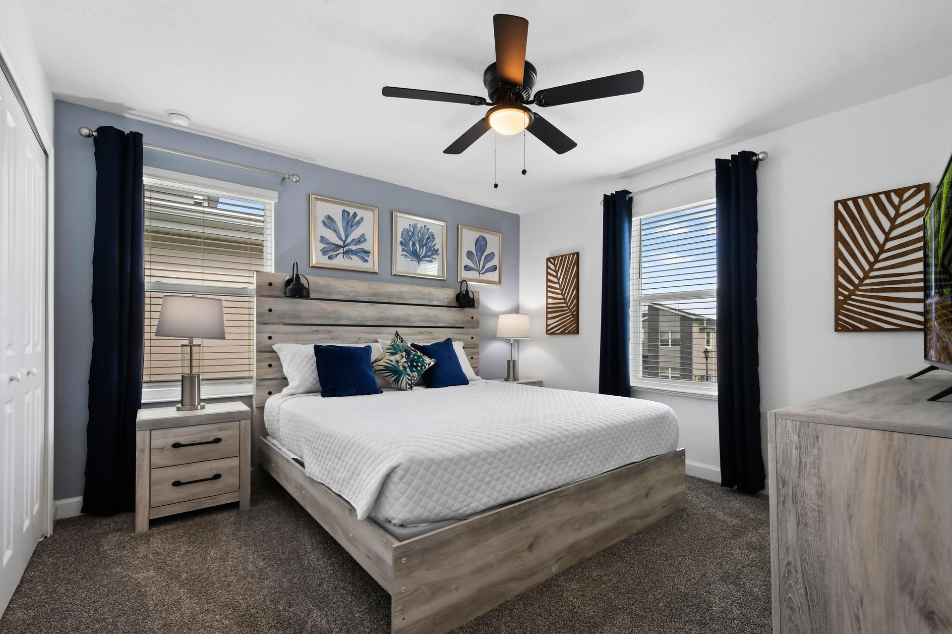 Coastal-inspired bedroom with a king bed, rustic wood accents, and serene decor.