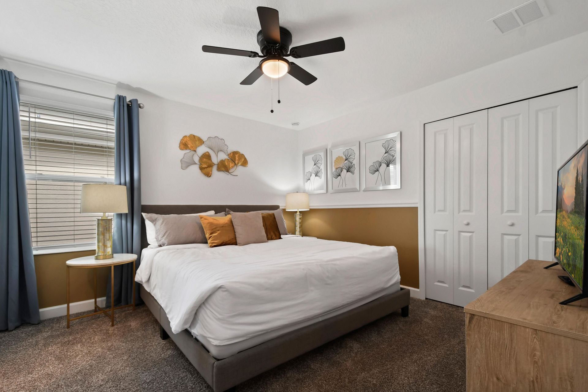 Elegant bedroom with a king bed, gold accents, and a cozy, stylish ambiance.