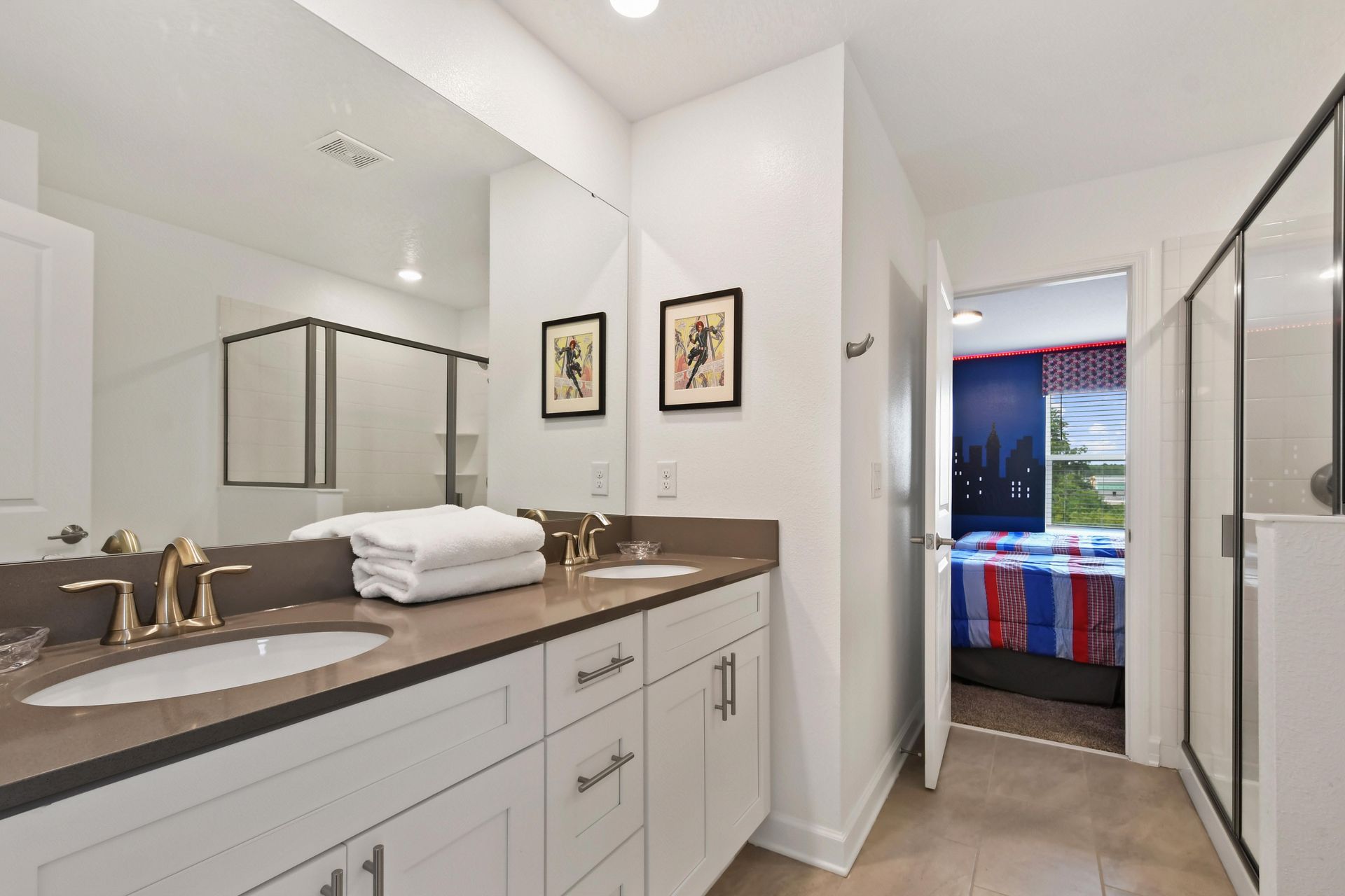 Modern bathroom with a dual-sink vanity, sleek finishes, and a spacious glass shower.
