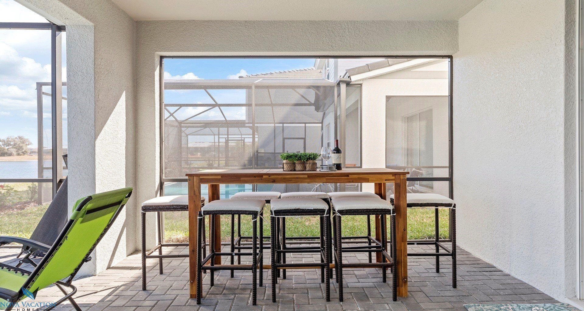Patio table and chairs beside private pool and spa.
