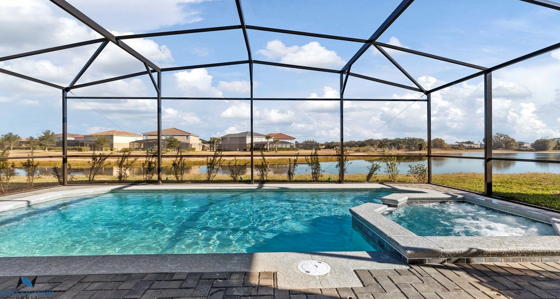 Private pool and spa with a calming lake side view.