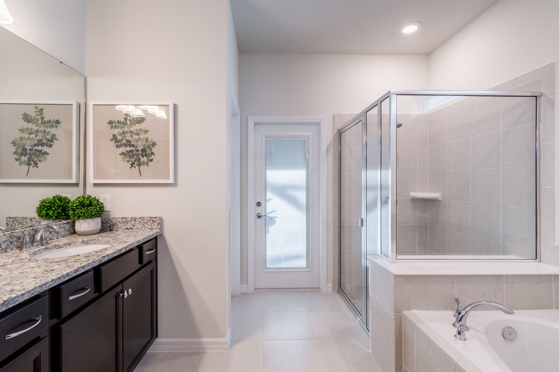 Elegant spa-like bathroom with a walk-in shower, soaking tub & modern finishes!