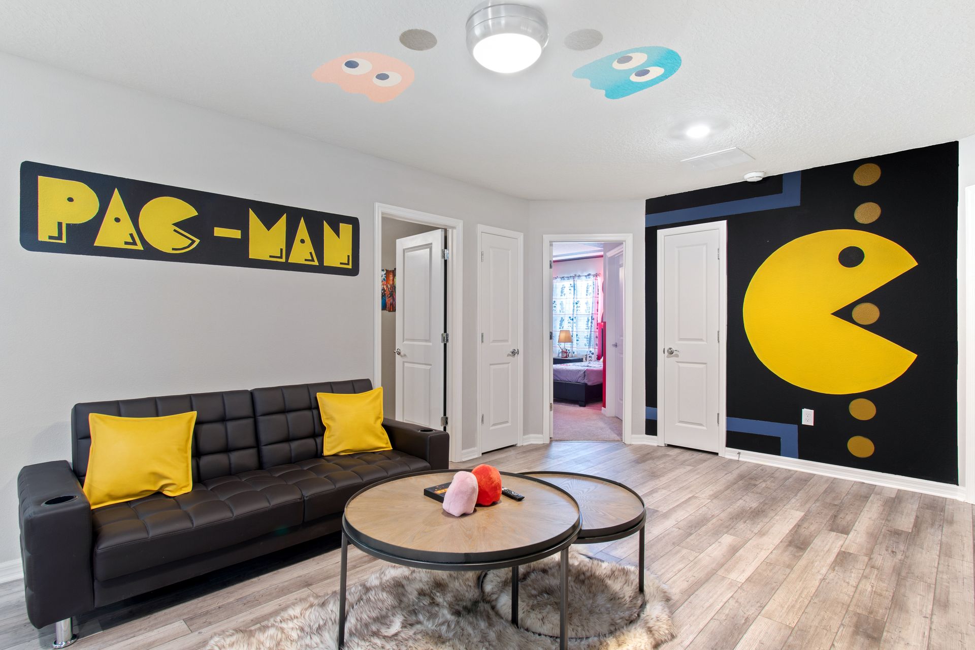 Retro Pac-Man lounge with arcade-inspired décor, cozy seating & fun gaming vibes!