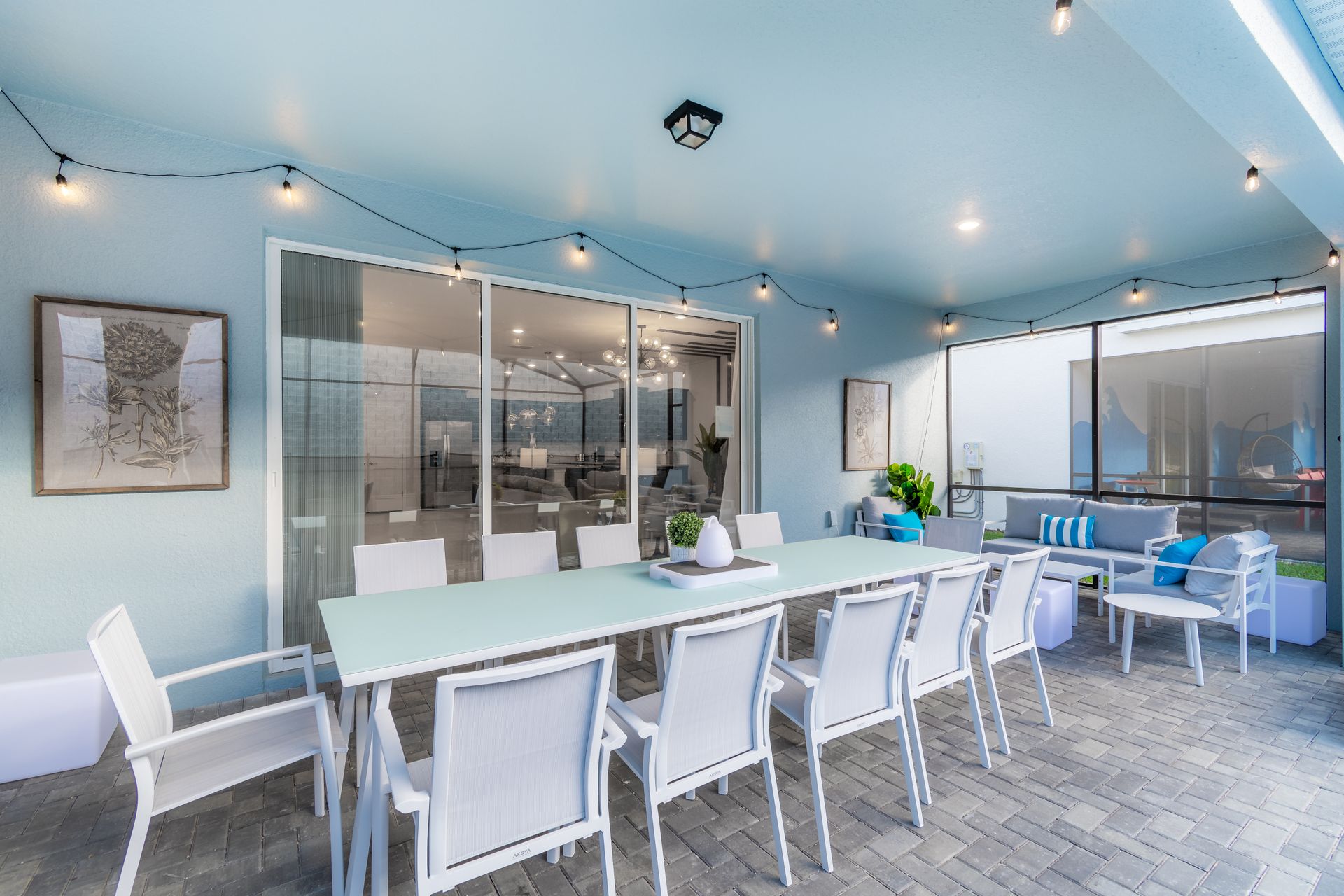 pacious covered patio with elegant dining, cozy seating & charming string lights!