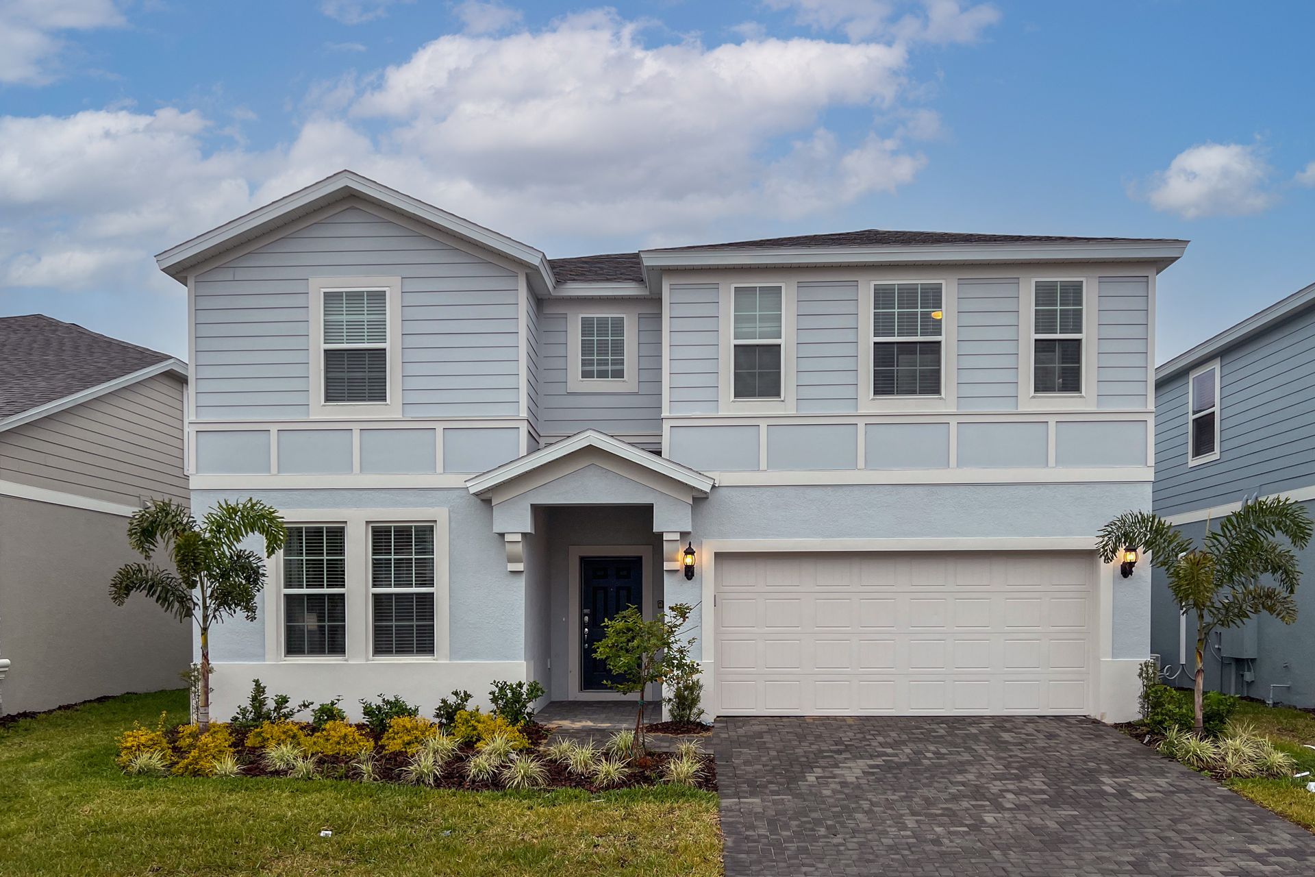 Spacious two-story home with modern exterior, garage, and landscaped yard.