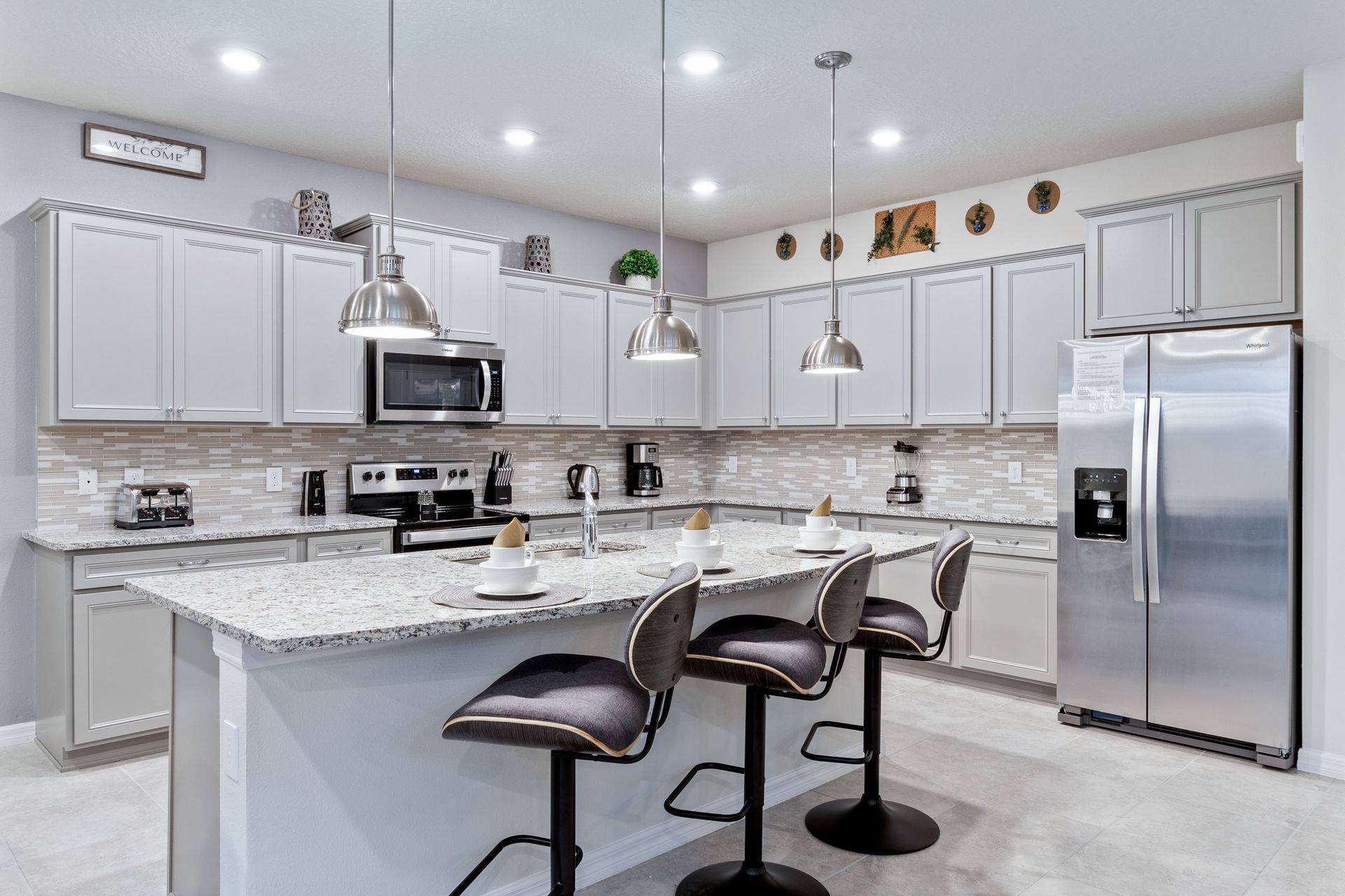 Modern kitchen with sleek stainless steel appliances and a spacious island.