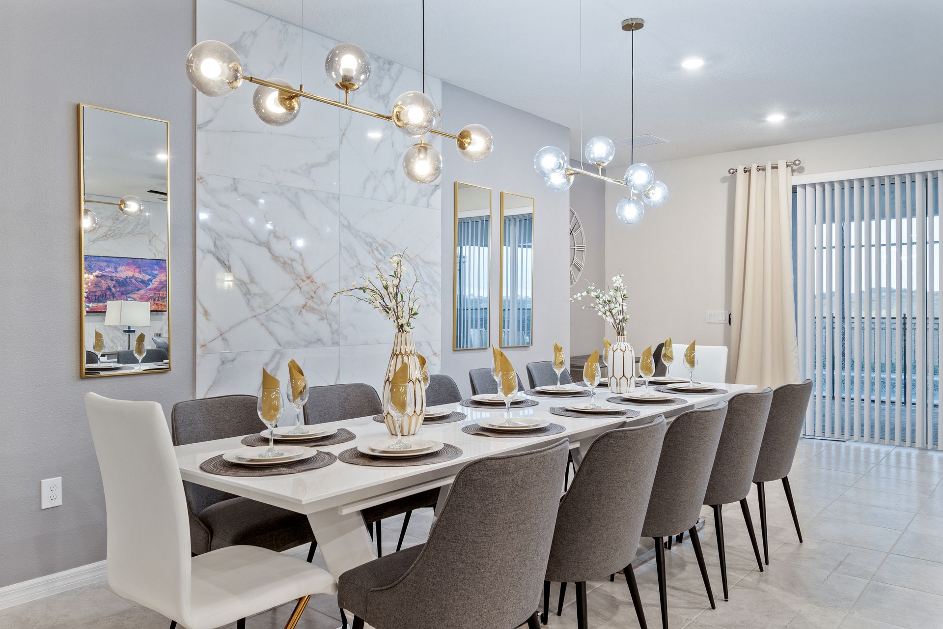 Sleek dining area with seating for 12, modern lighting, and marble accents.