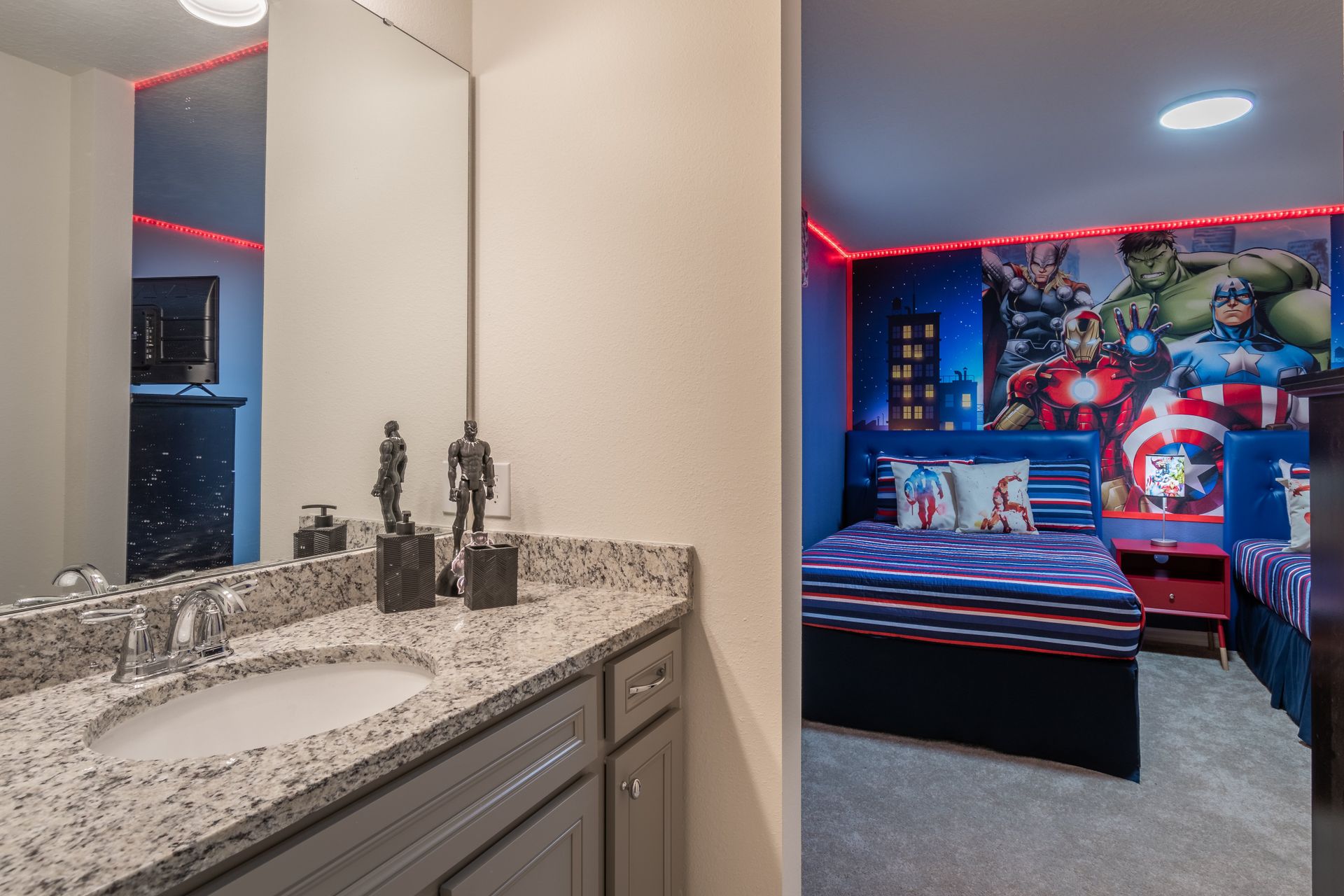 Granite bathroom with superhero-themed bedroom view, perfect for kids.