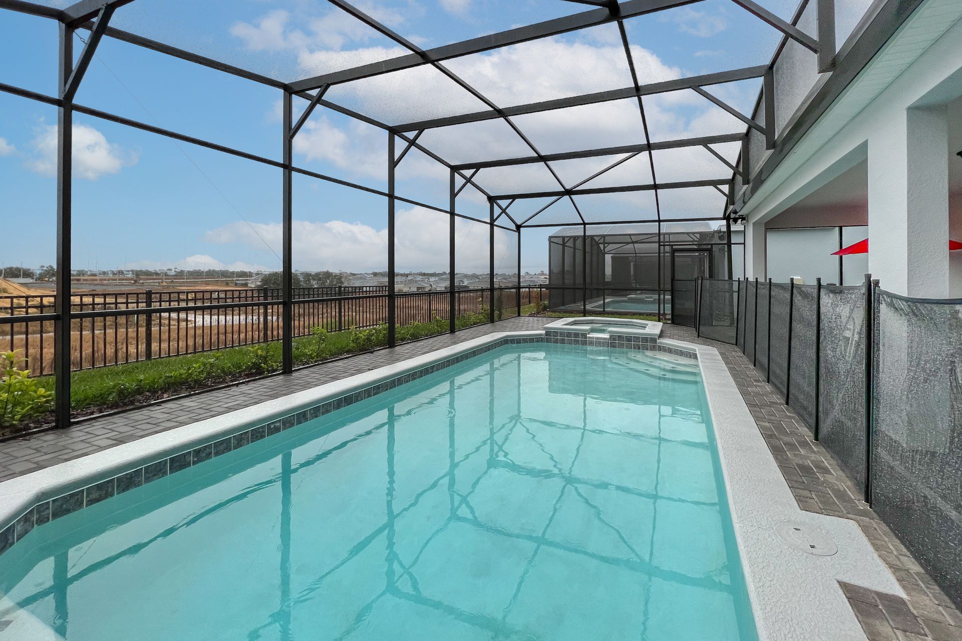 Private screened-in pool with spa and sun deck, perfect for relaxation.