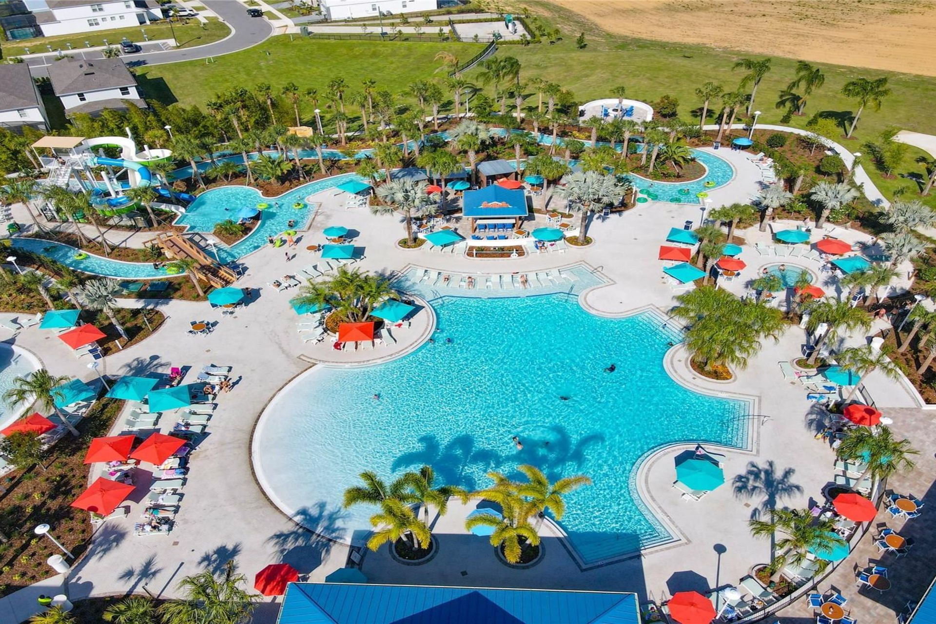 Aerial view of Windsor Island Resort's expansive pool area with water slides, lazy river, and vibrant lounge spaces.