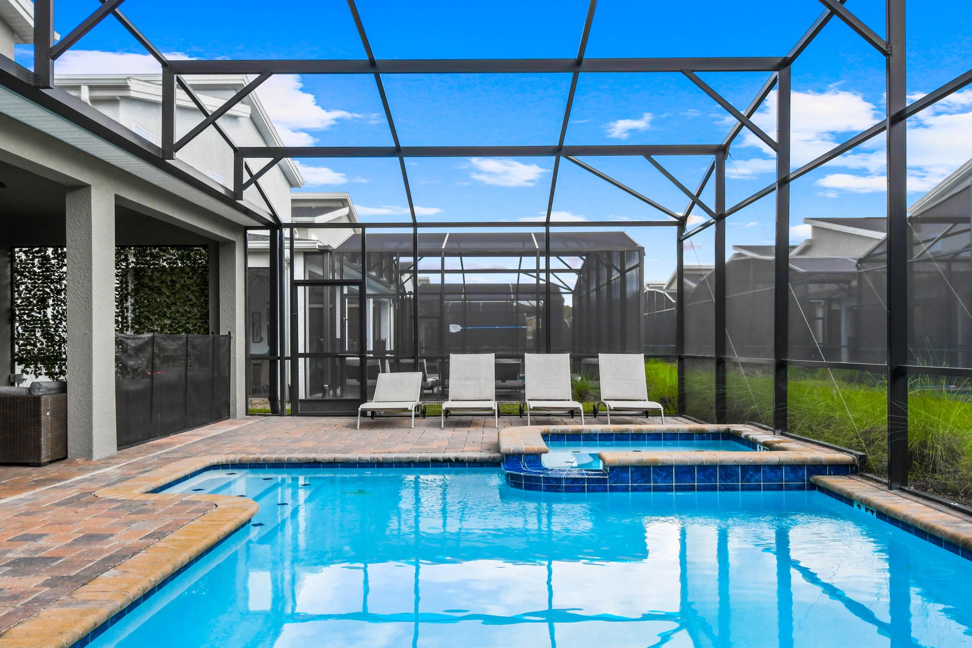 Relax in a private screened pool and spa with lounge chairs and outdoor seating!