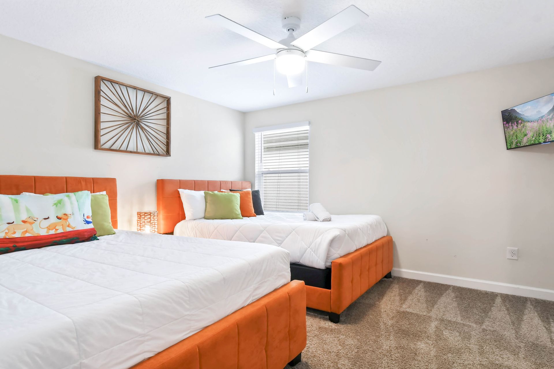 Bright and cheerful bedroom with twin beds, vibrant decor, and a playful ambiance!