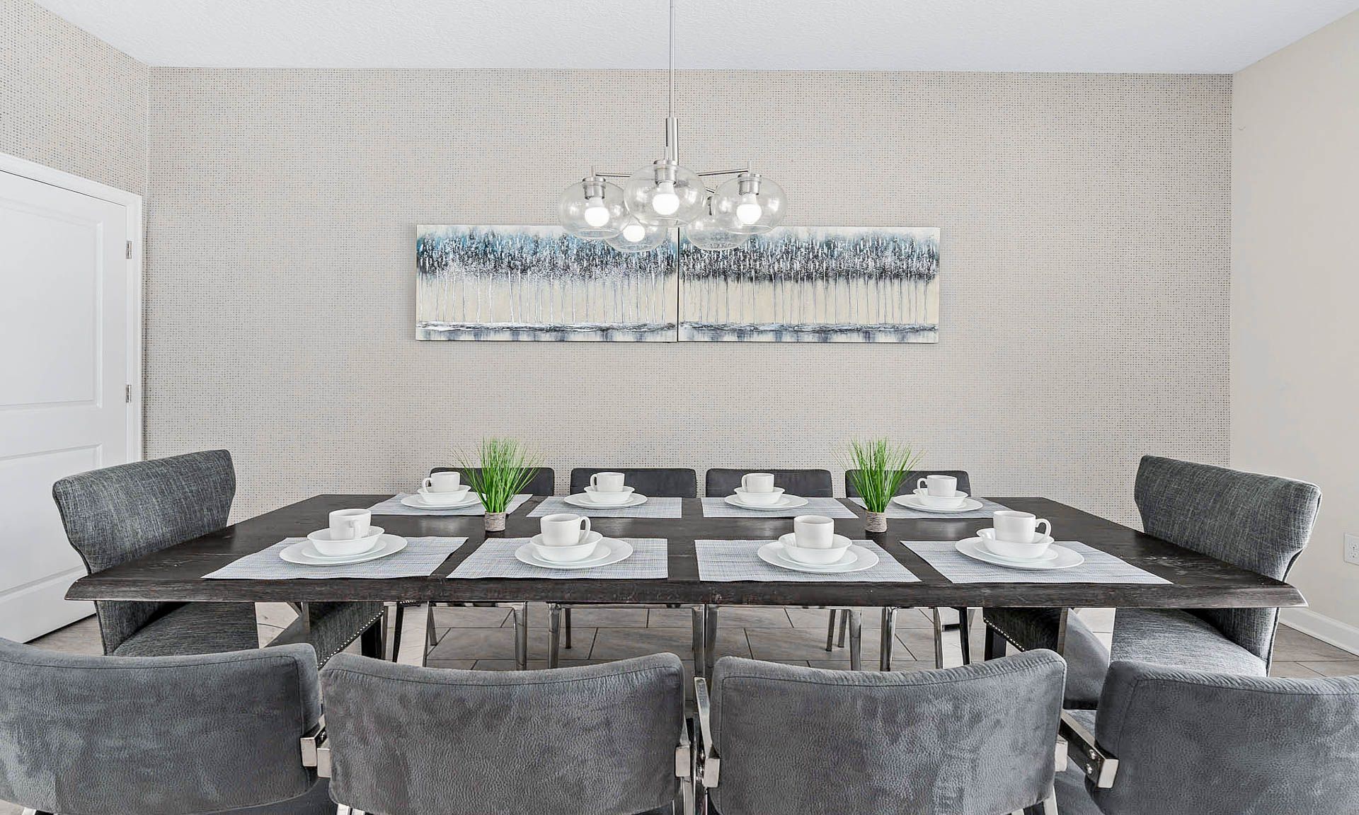 Elegant dining room with seating for eight, modern lighting, and serene decor!