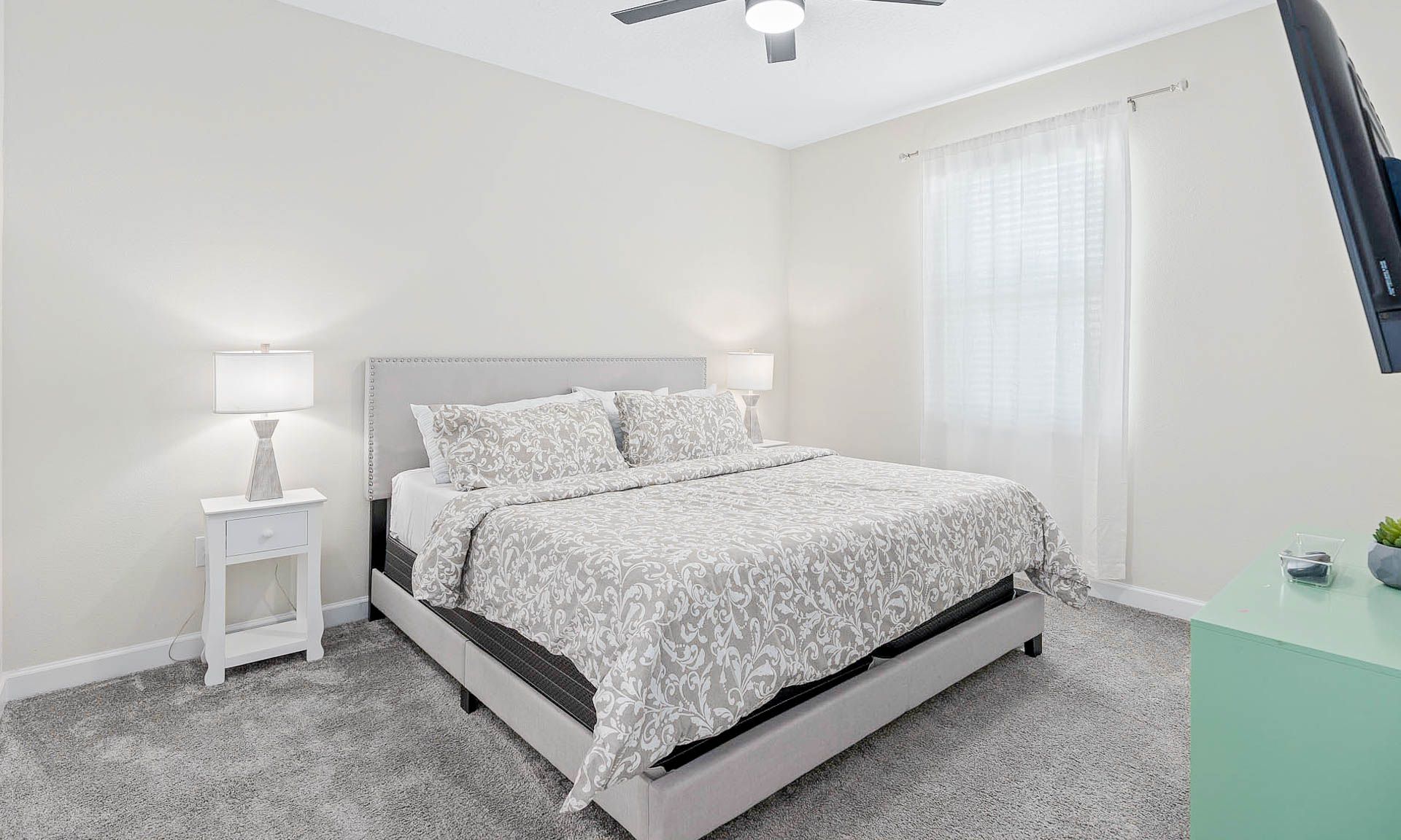 Serene bedroom with soft decor, king-size bed, natural light, and cozy ambiance!