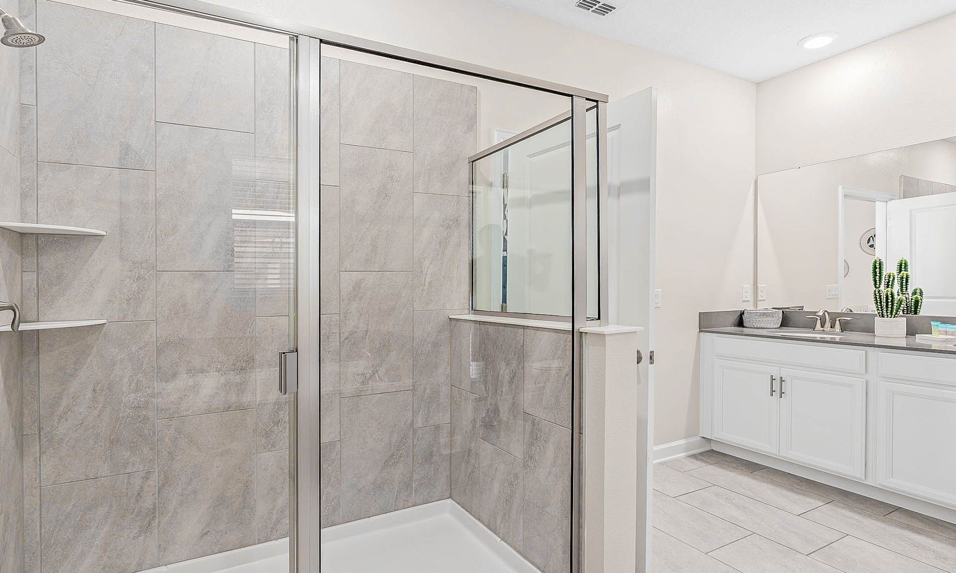 Modern bathroom with a spacious walk-in shower, dual vanity, and sleek finishes!