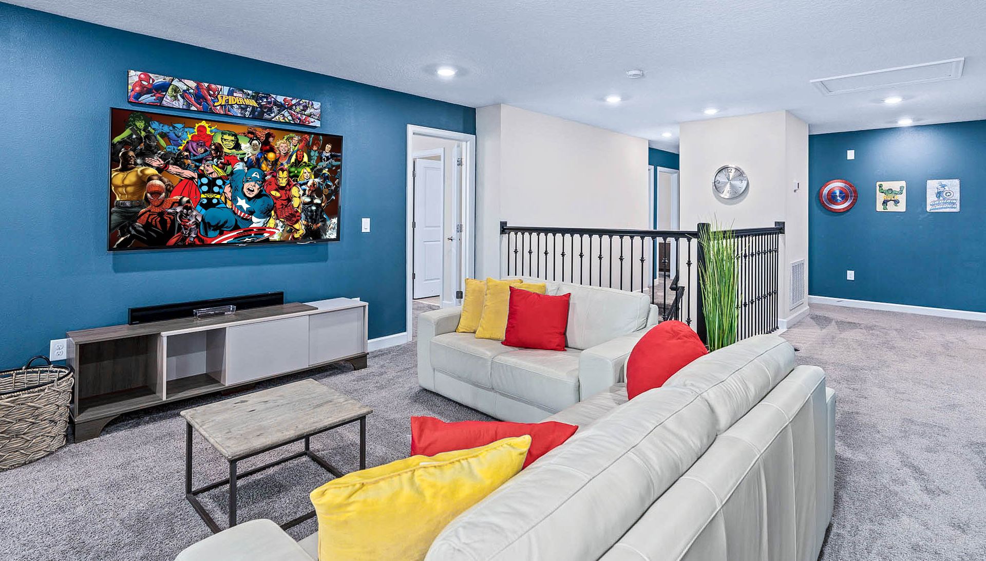 Superhero-themed lounge with cozy seating, vibrant decor, and a big-screen TV!