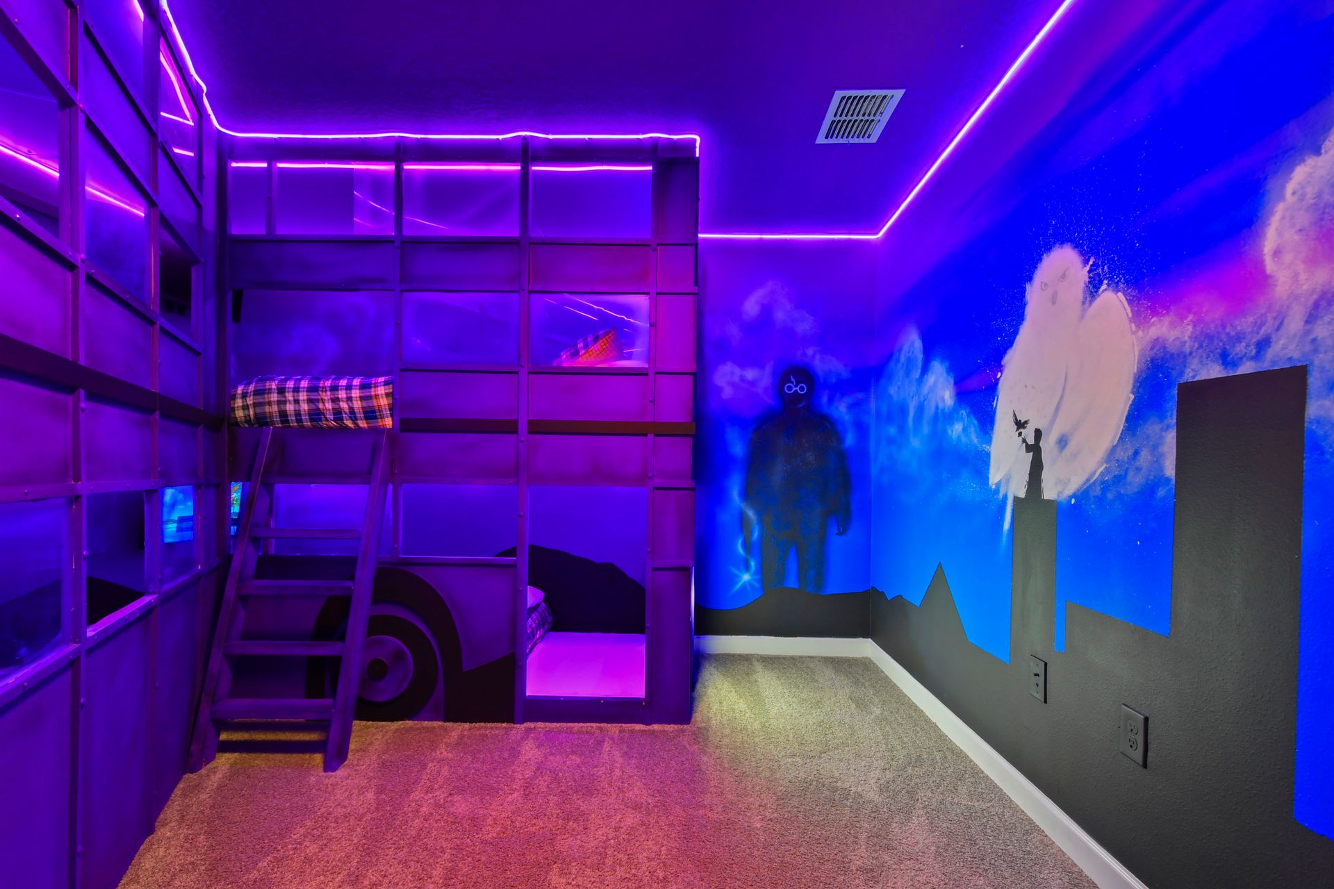 Epic superhero-themed bunk room with glowing neon lights, bold murals, and cozy beds!