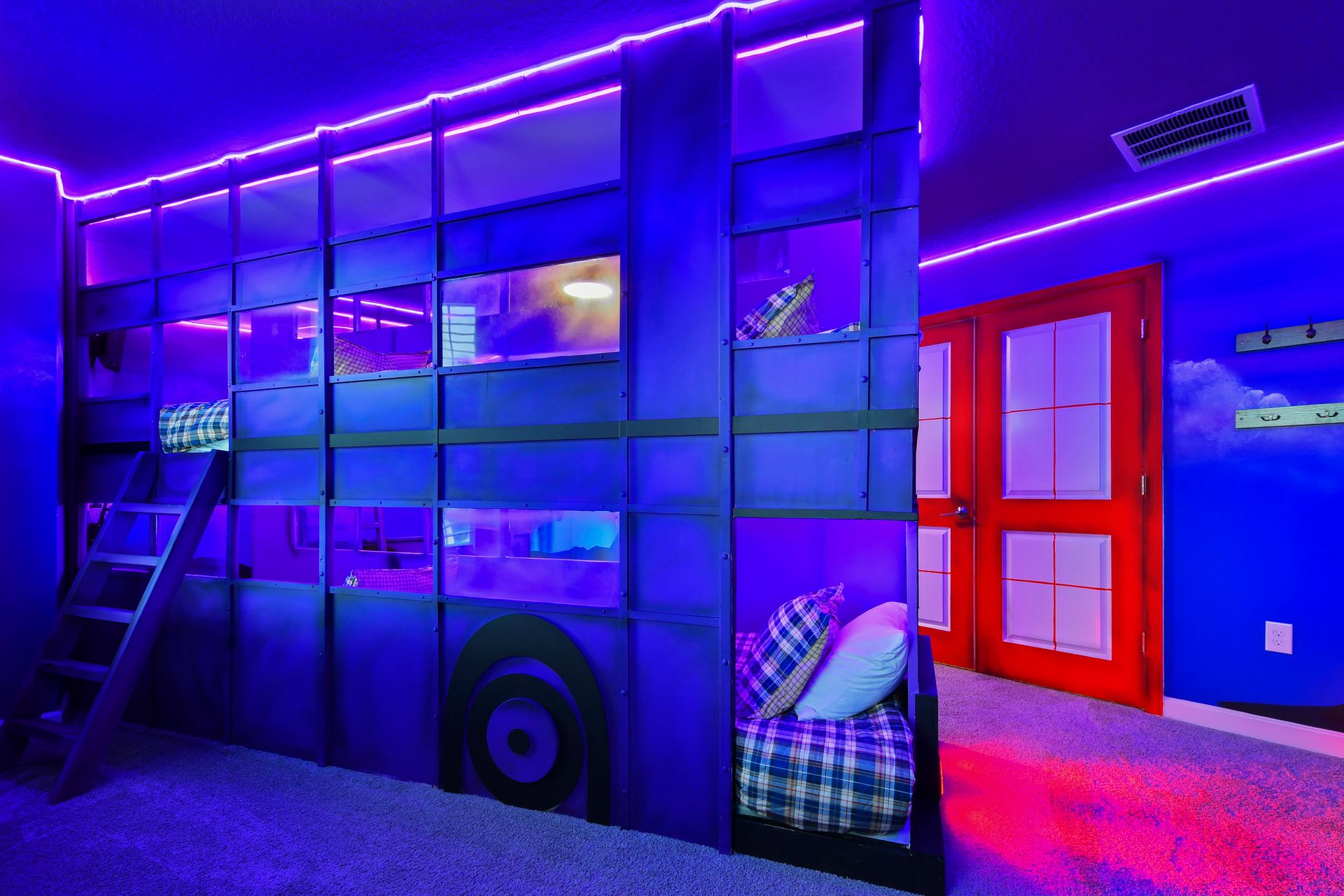 Immersive neon-lit bunk room with creative design, cozy beds, and vibrant energy!