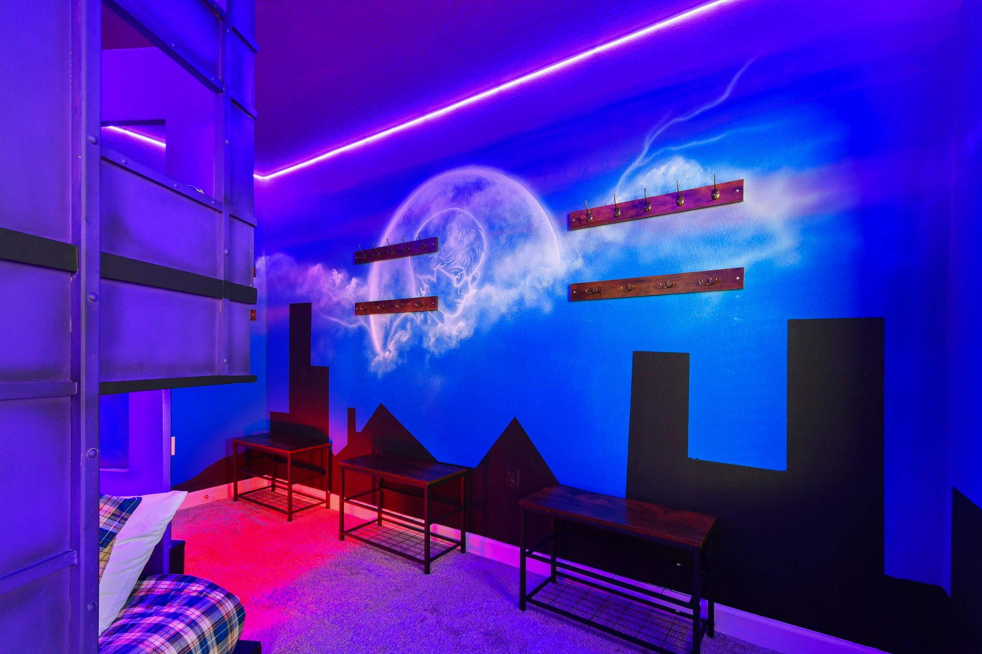 Immersive superhero-themed room with glowing moon mural, cityscape design, and hooks for capes!