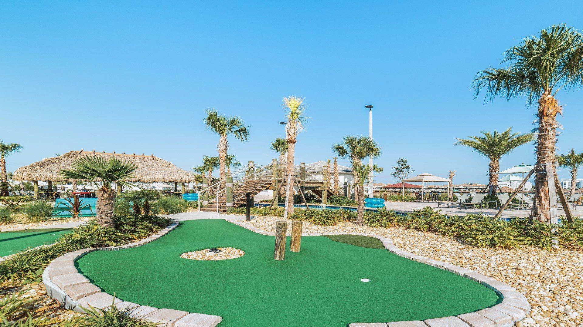 Challenge friends to mini-golf in a tropical paradise with resort vibes all around!