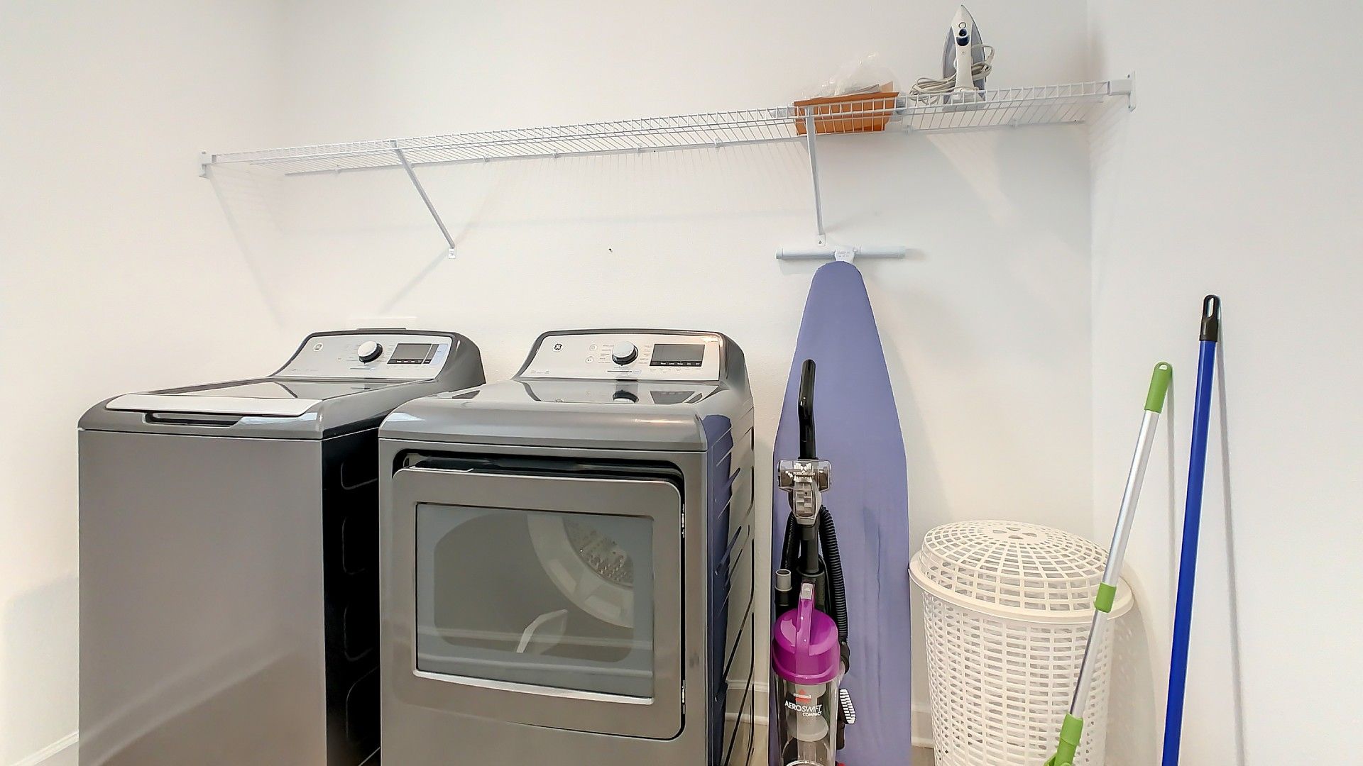 Efficient and compact laundry room equipped with everything you need to make washing day a breeze!