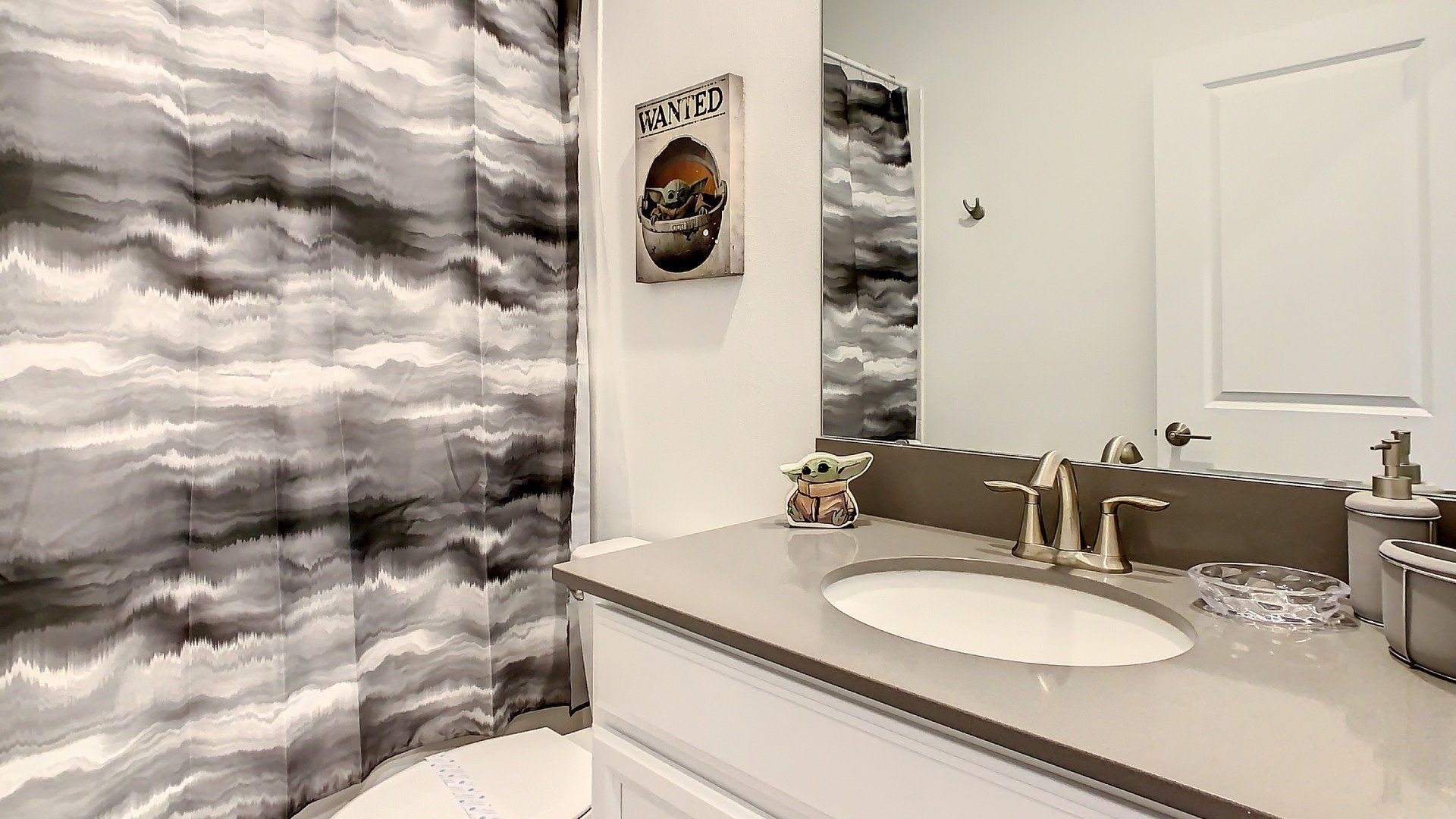 Bright and clean bathroom with elegant granite countertops, perfect for refreshing mornings.