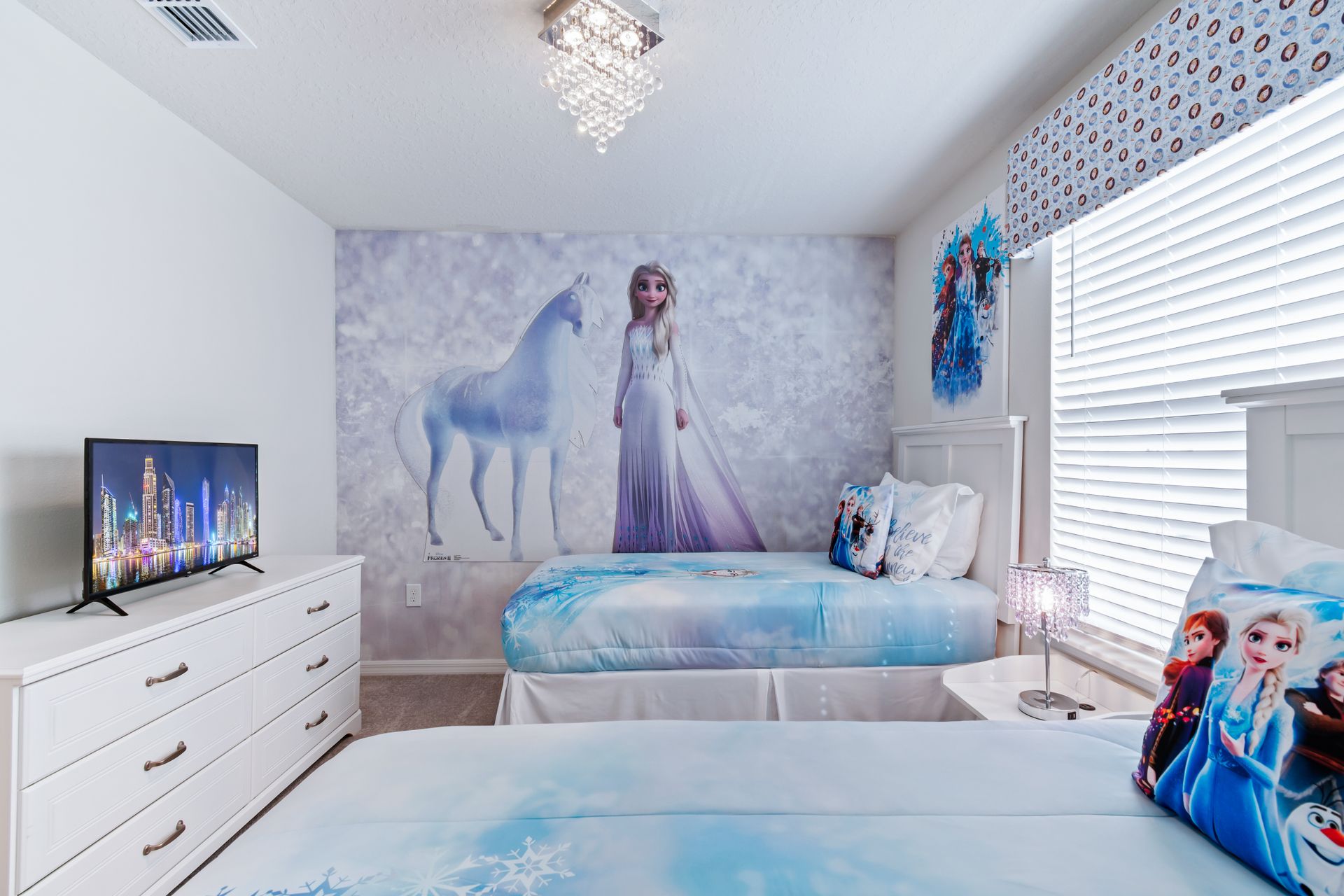 Children will delight in the enchanting upstairs bedroom adorned with a captivating Frozen theme, creating a magical and memorable space