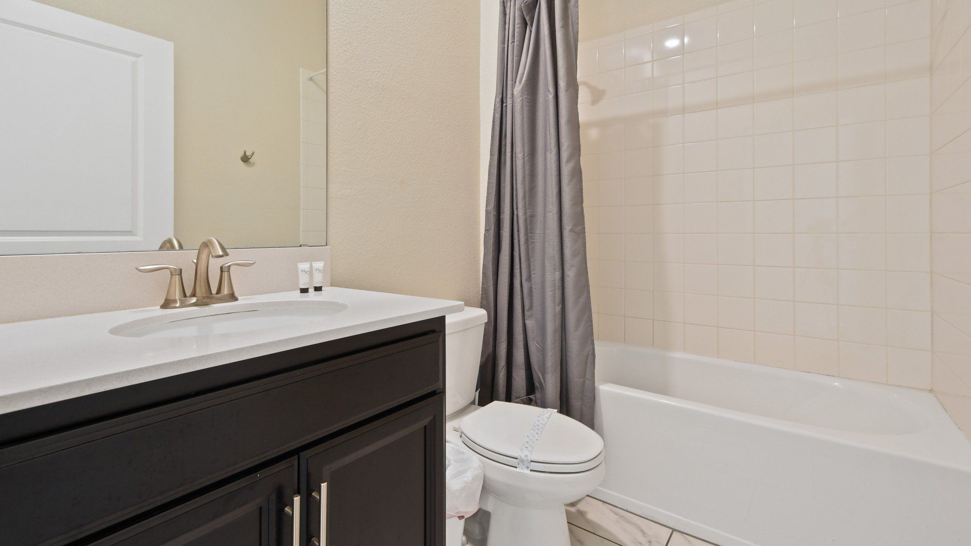 Luxurious bathroom with a double vanity, sleek marble shower, and modern finishes