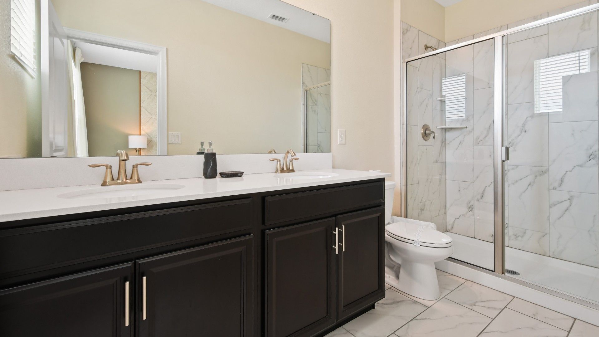 Modern and stylish bathroom with elegant finishes, a vibrant shower curtain, and a clean design