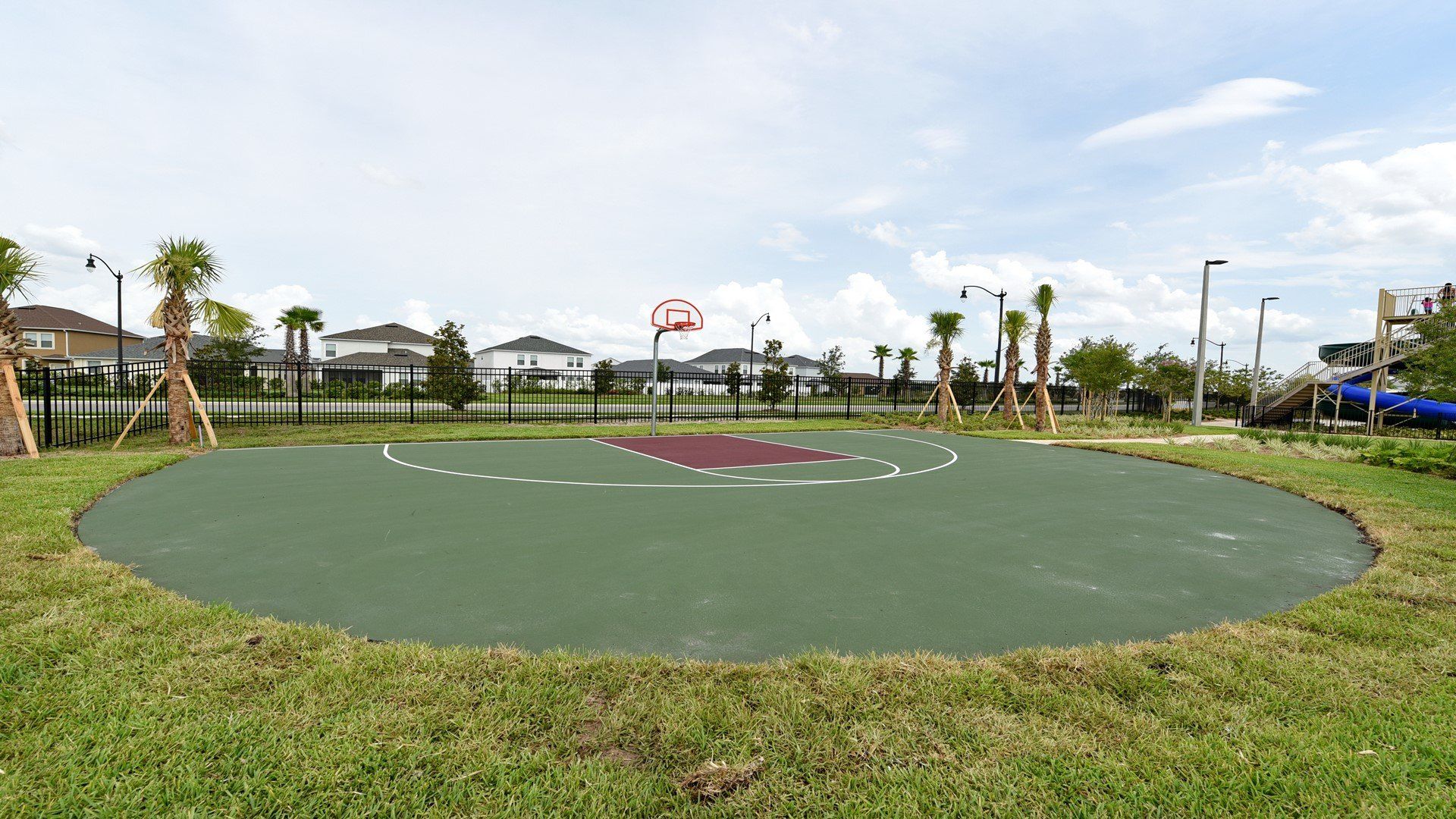 Shoot hoops on a private half-court surrounded by palms and open skies.