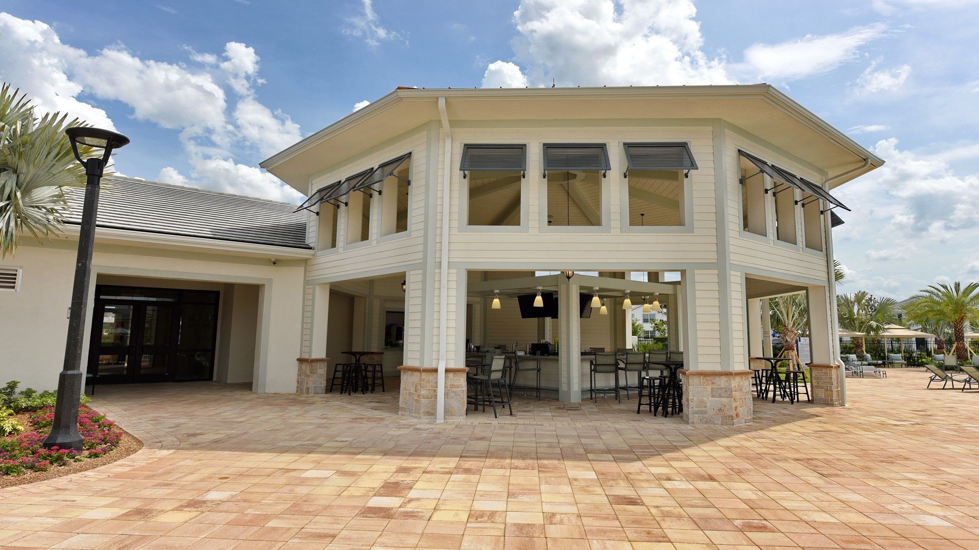 Chic open-air clubhouse with bar seating, perfect for poolside cocktails.