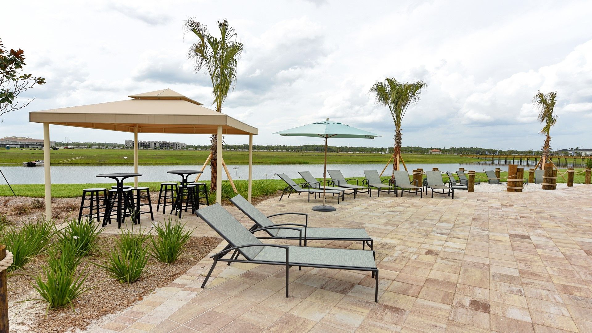 Relax lakeside with resort vibes, loungers, shade, and stunning water views.