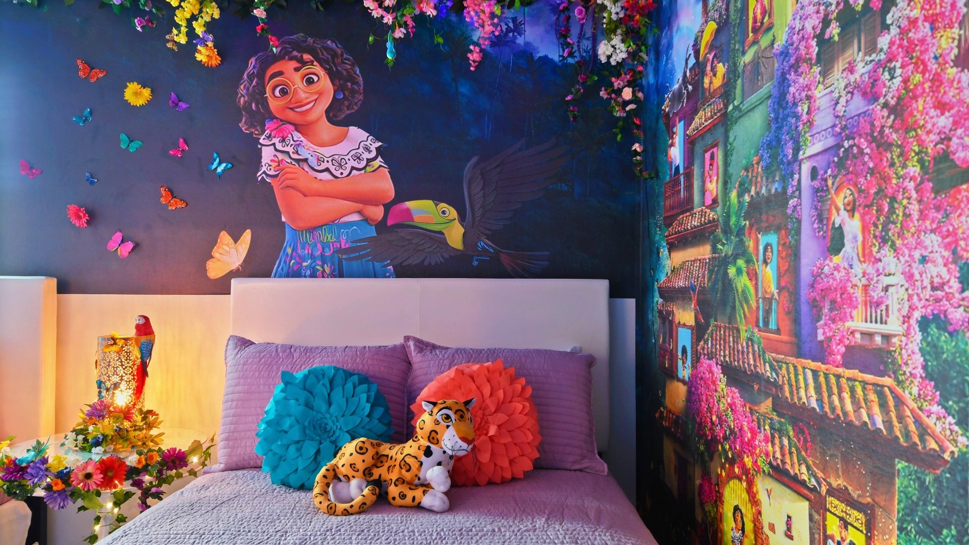 Vibrant Encanto-themed bedroom with colorful florals, magical murals, and cozy beds.