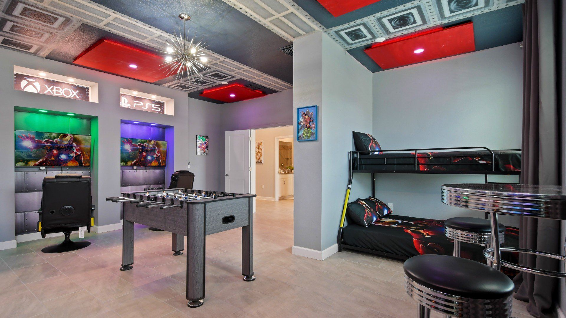 Ultimate superhero gaming room with PS5, Xbox, foosball, bunk beds, and epic décor.