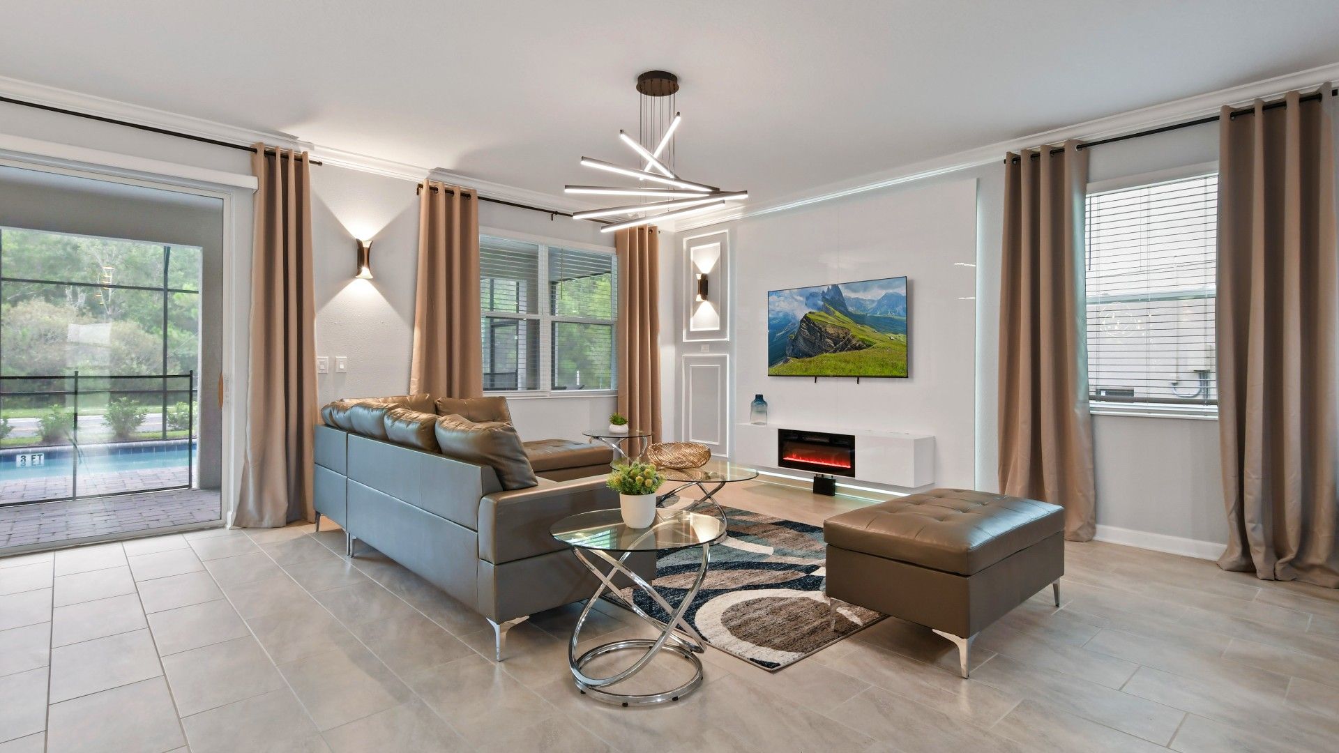 Stylish modern living room with sleek décor, cozy fireplace, and pool access.