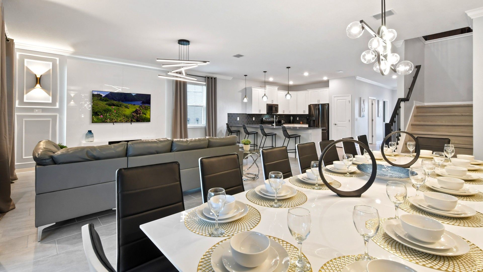 Modern open-concept dining and living space with elegant décor and a sleek kitchen.