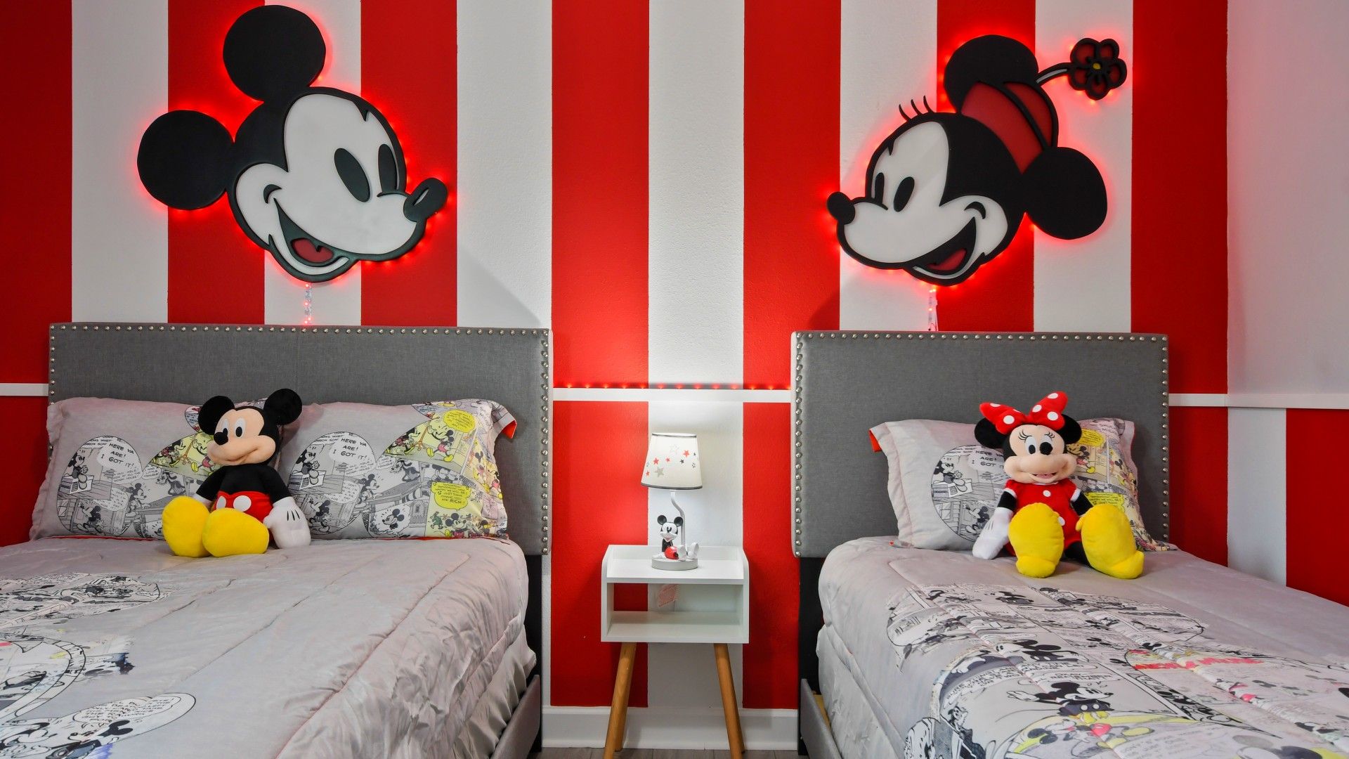 Charming Mickey Mouse-themed bedroom with bold red accents and nostalgic décor.