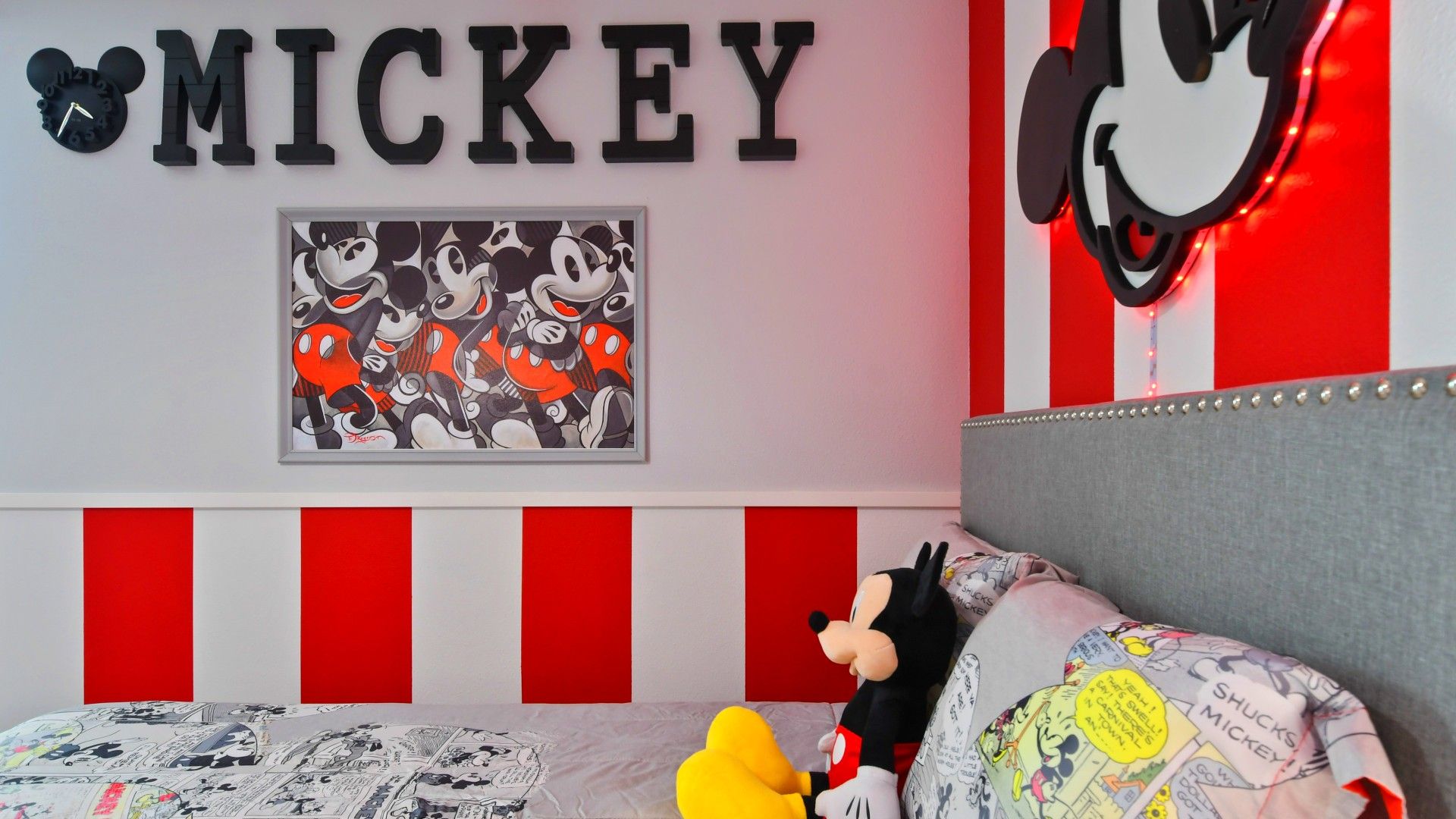 Charming Mickey Mouse-themed bedroom with bold red accents and nostalgic décor.