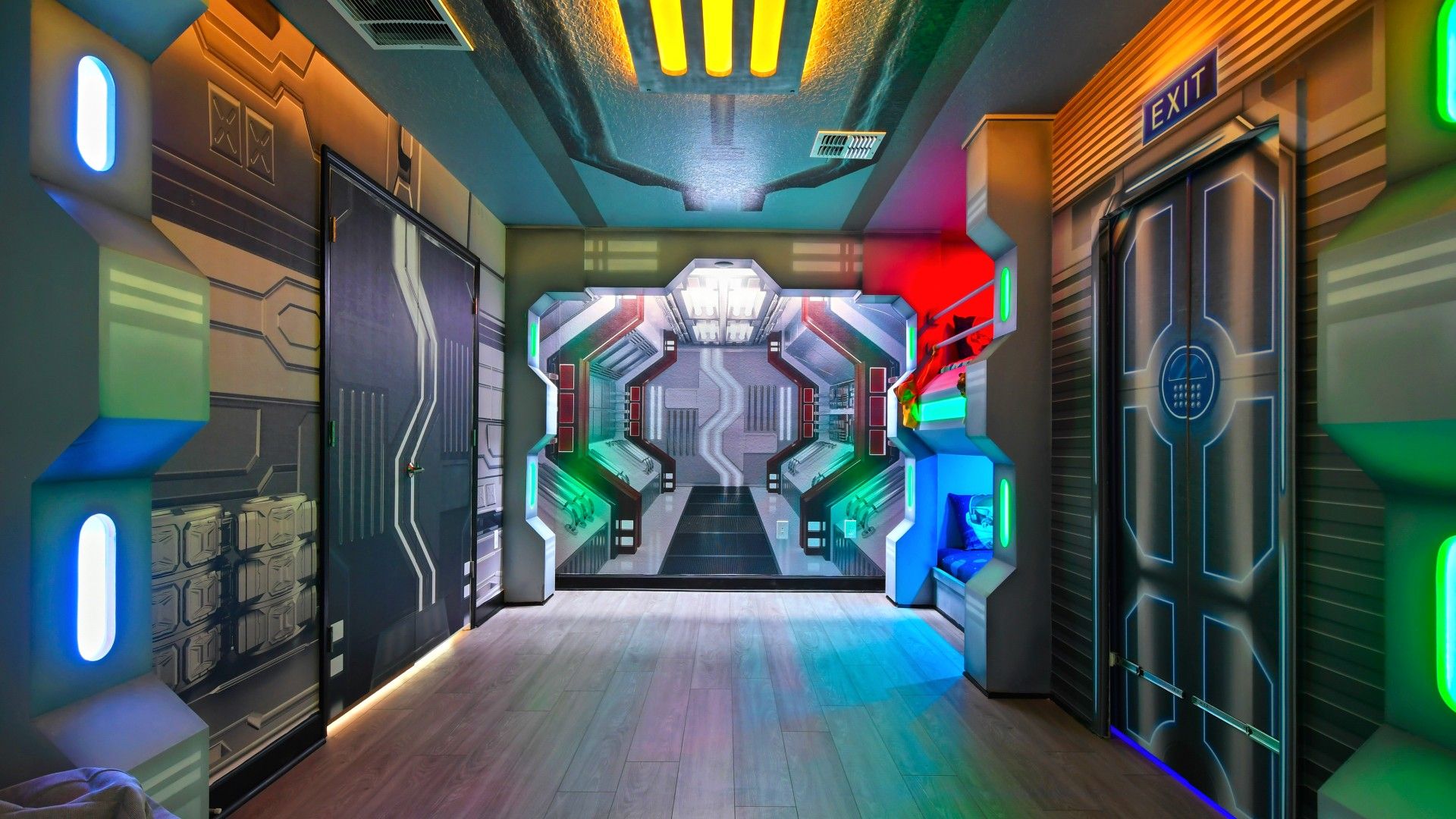Immersive space-themed room with futuristic lighting, cosmic décor, and bunk beds.
