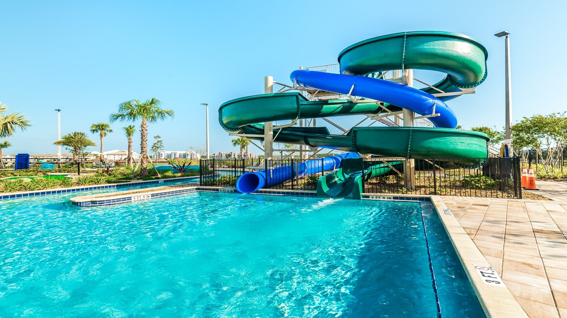 Resort Amenities - Experience pure exhilaration as you glide down the twisting slide into the refreshing waters of the resort pool, making unforgettable memories right at your doorstep.