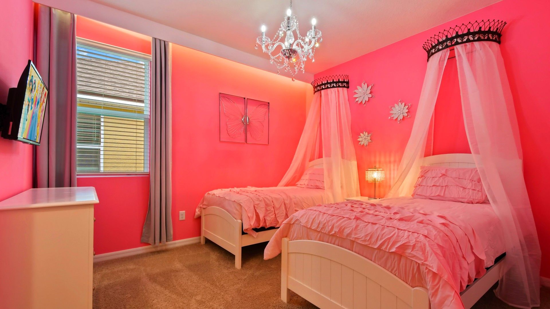Charming princess-themed room with canopy beds, elegant decor, and pink bliss!