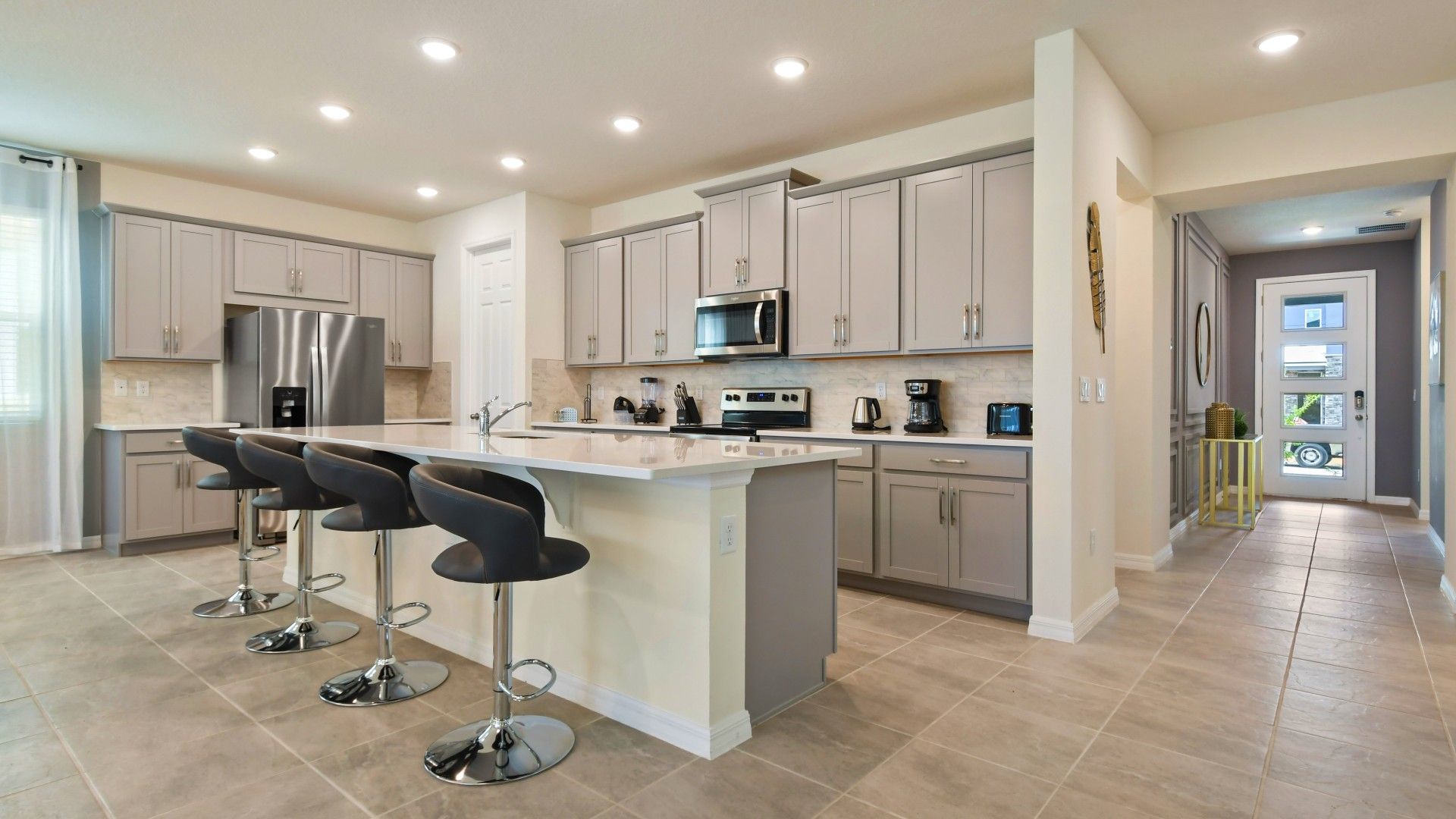 Stunning modern kitchen with sleek gray cabinets, spacious island, and chic bar seating!