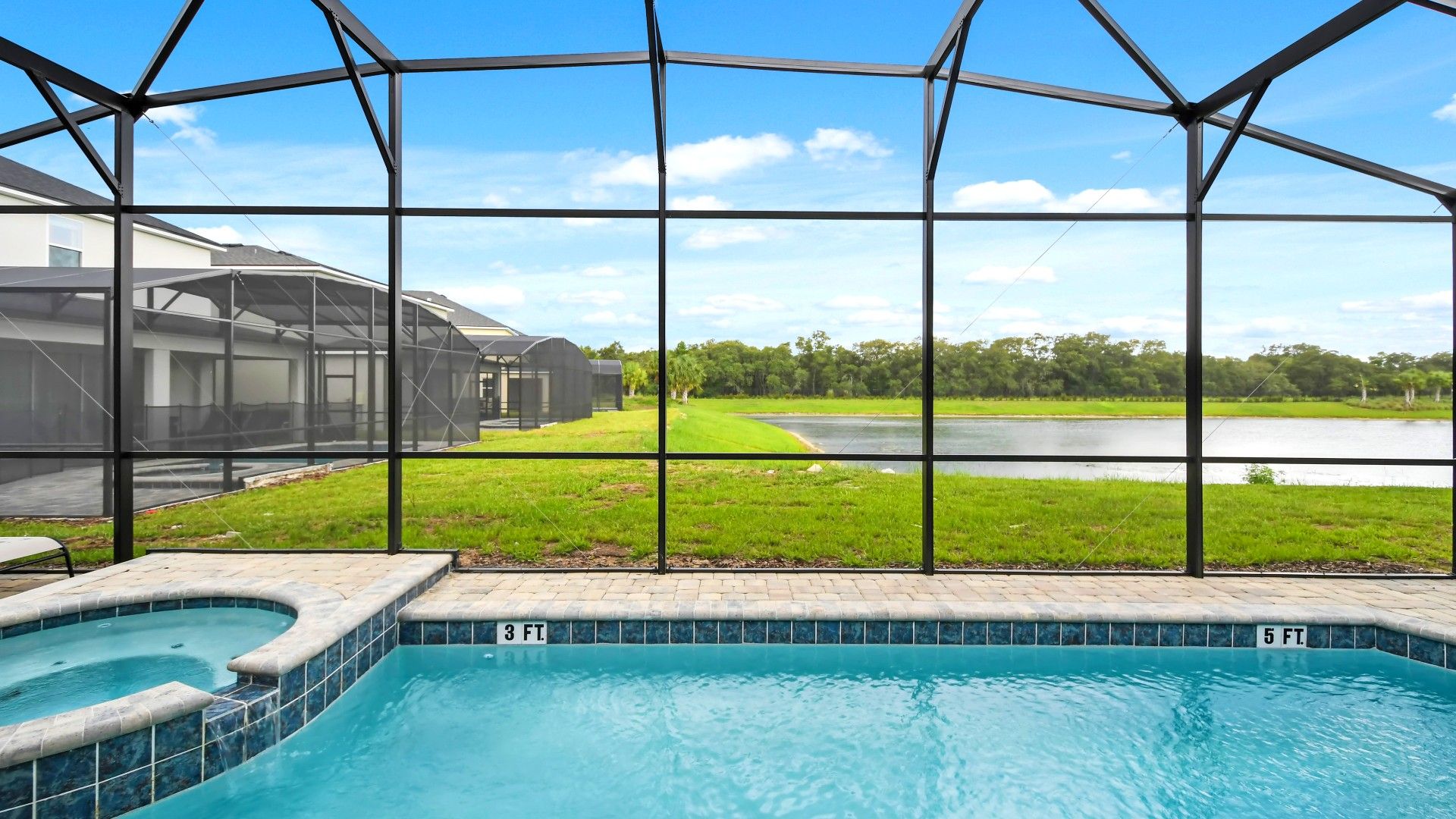 Relax by the pool in this serene lakeside retreat with a screened lanai view!