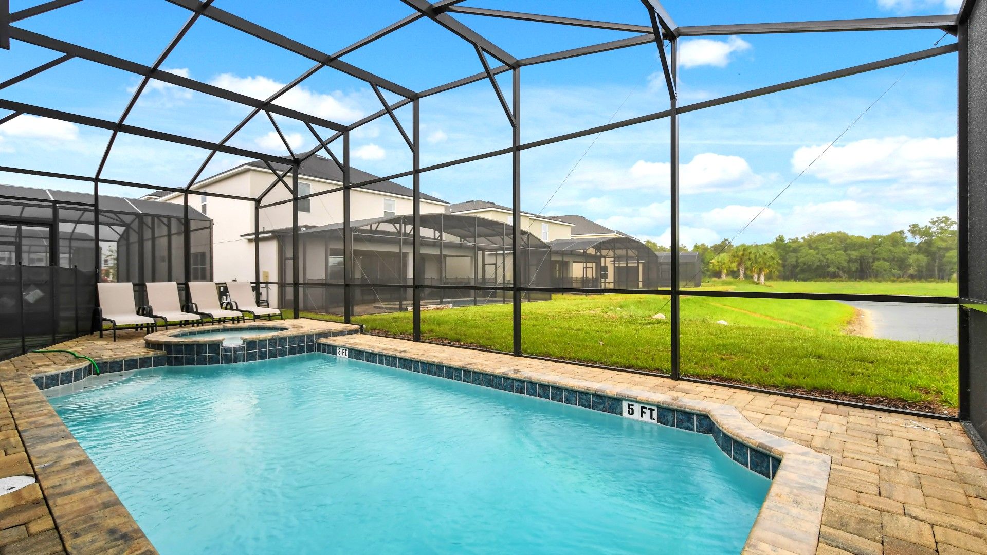 Enjoy a private screened pool with loungers, serene lake views, and sunny skies!