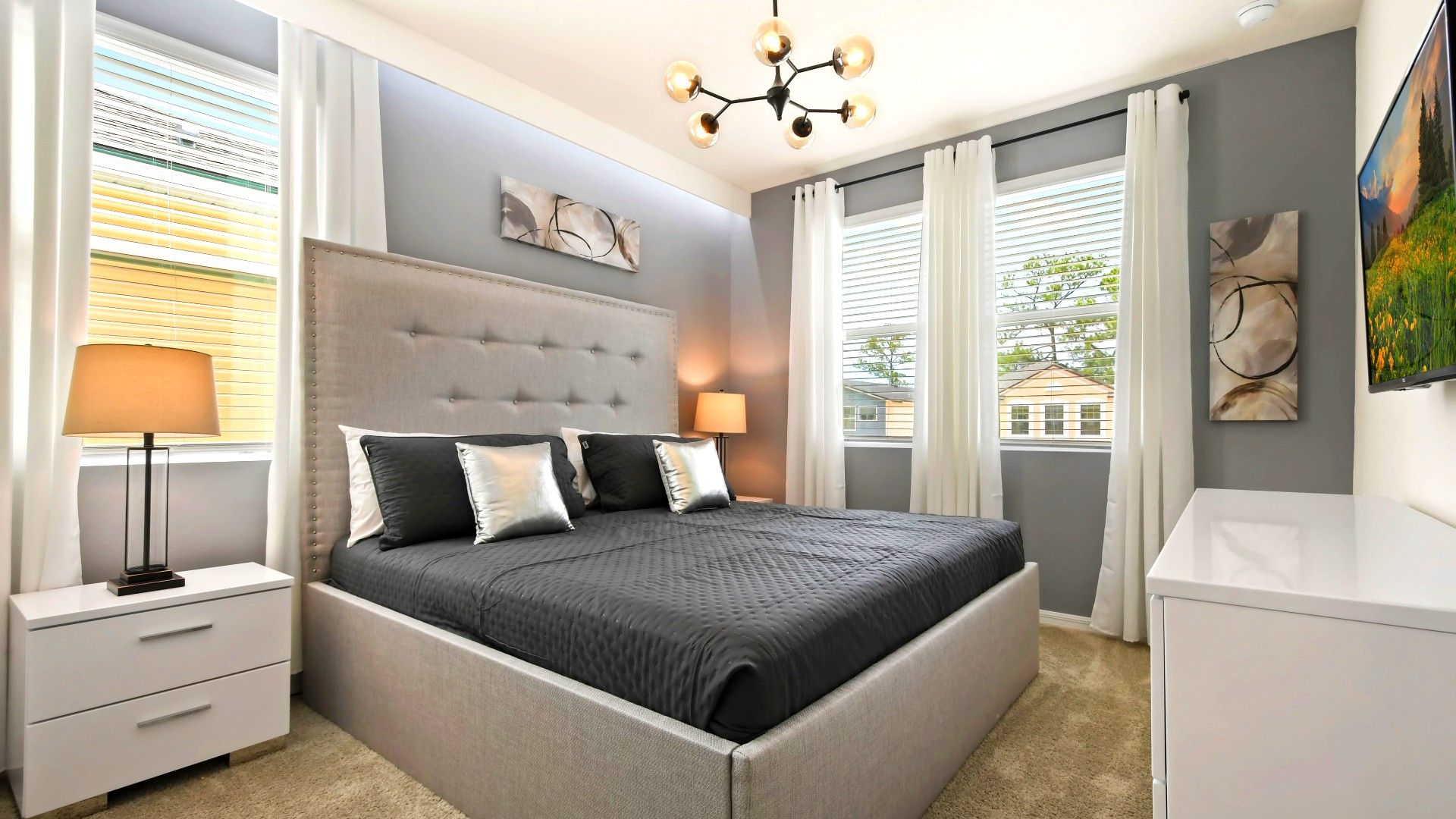 Modern, elegant bedroom with a plush king bed, stylish decor, and soft lighting!