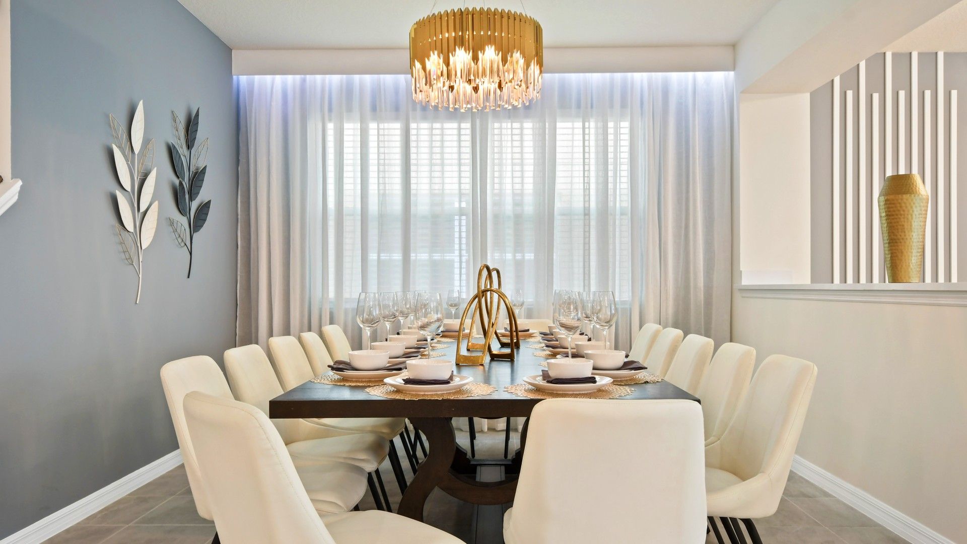 Elegant dining room with seating for 12, chic decor, and a stunning chandelier!