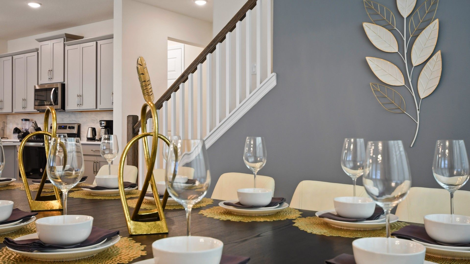 Stylish dining setup with modern gold accents, elegant tableware, and chic decor